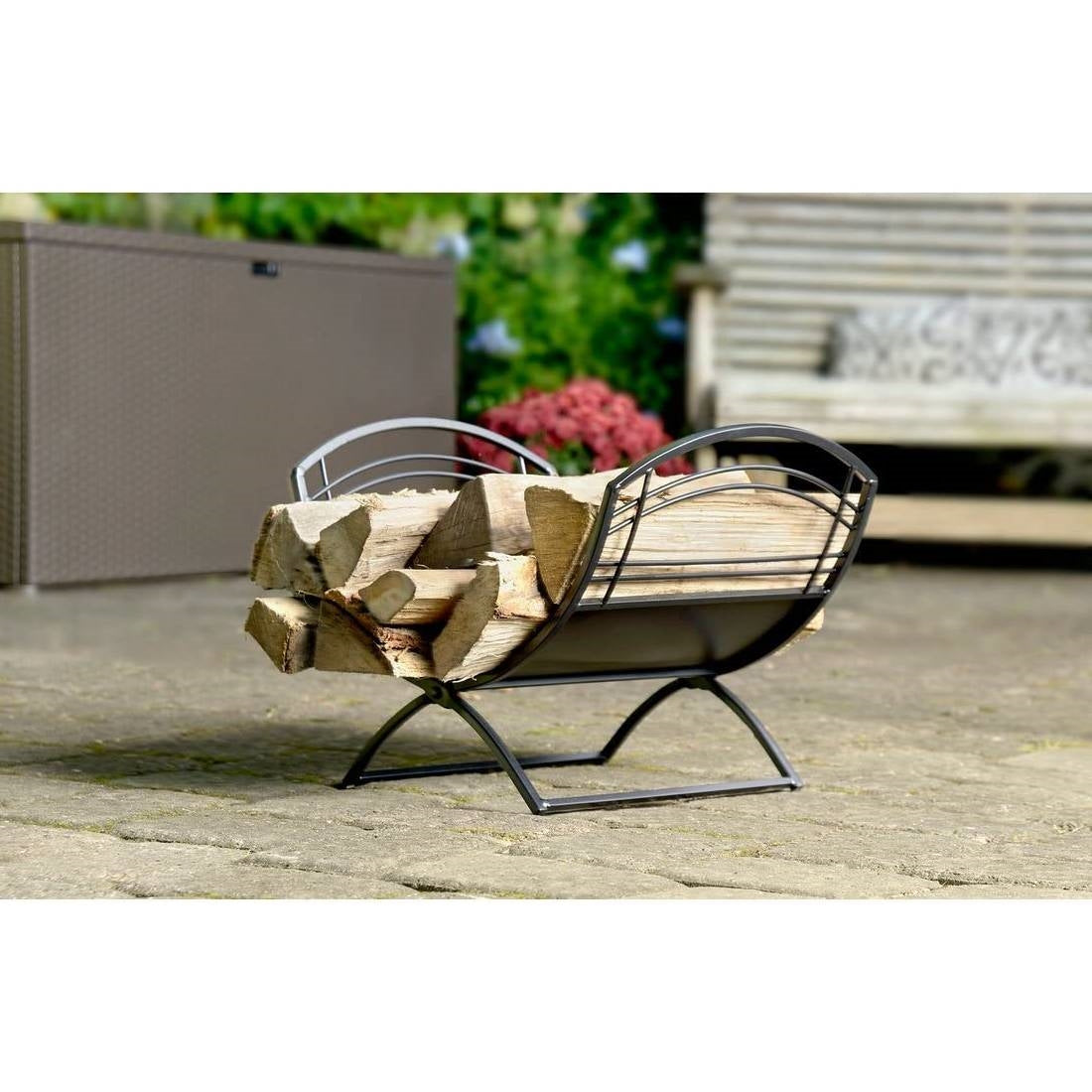 Decorative metal firewood holder with logs on a patio