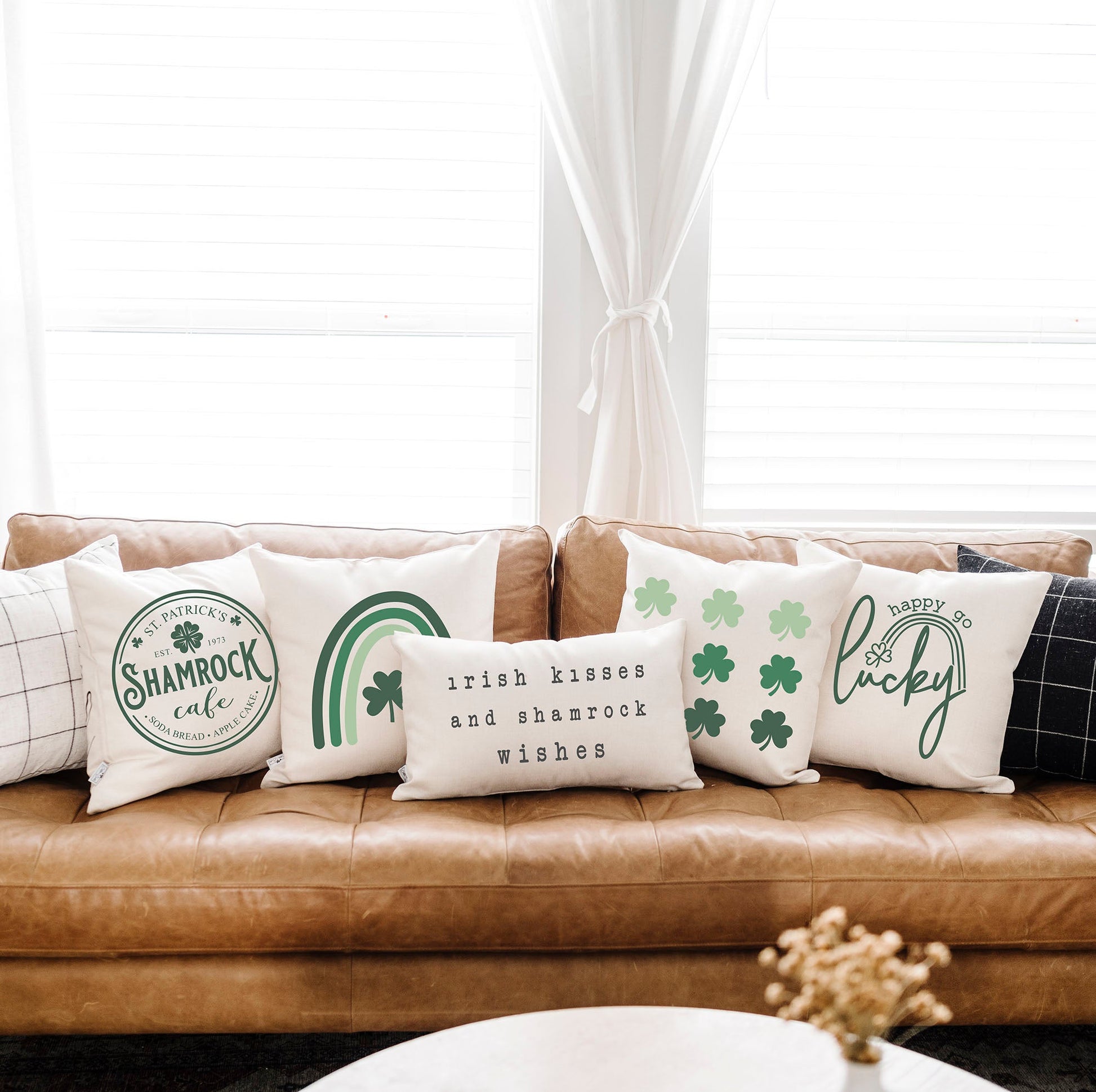 Heart with Clover 18x18 inch St Patrick's Day Pillow Cover on a couch with other festive pillows.