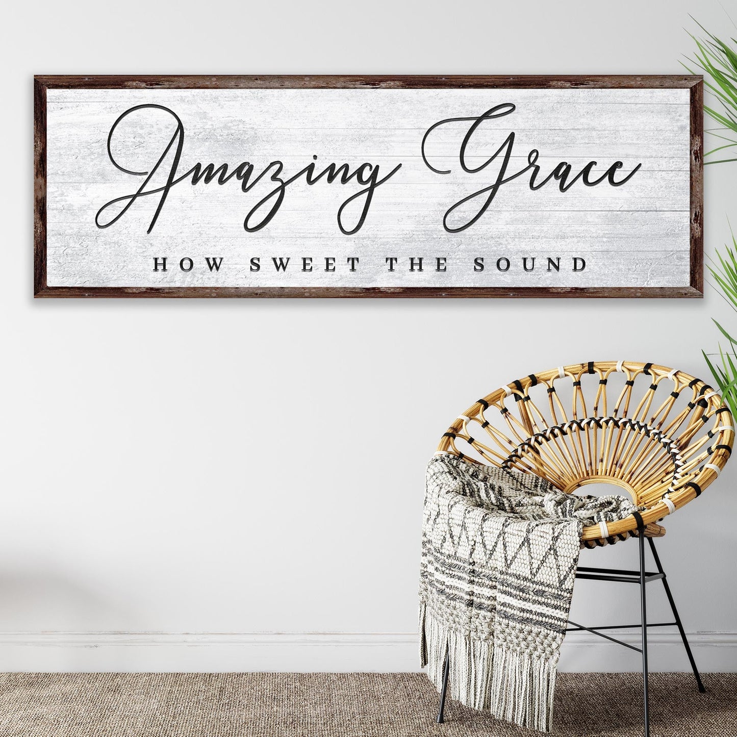 Decorative sign with 'Amazing Grace' text above a wicker chair with a blanket.