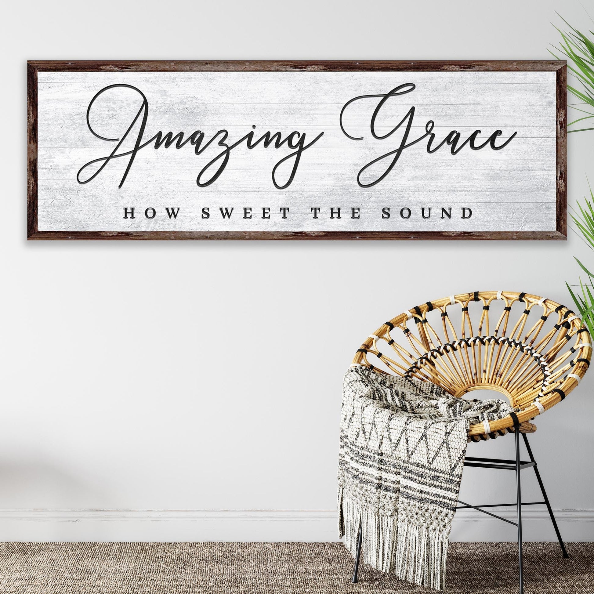 Decorative sign with 'Amazing Grace' text above a wicker chair with a blanket.