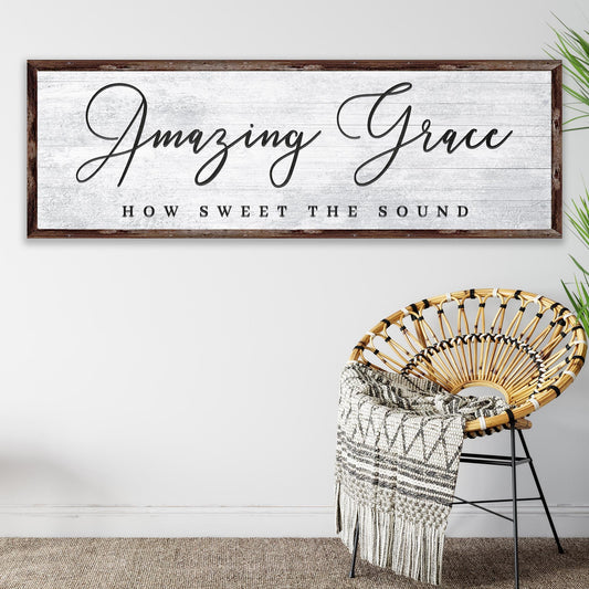 Decorative sign with 'Amazing Grace' text above a wicker chair with a blanket.
