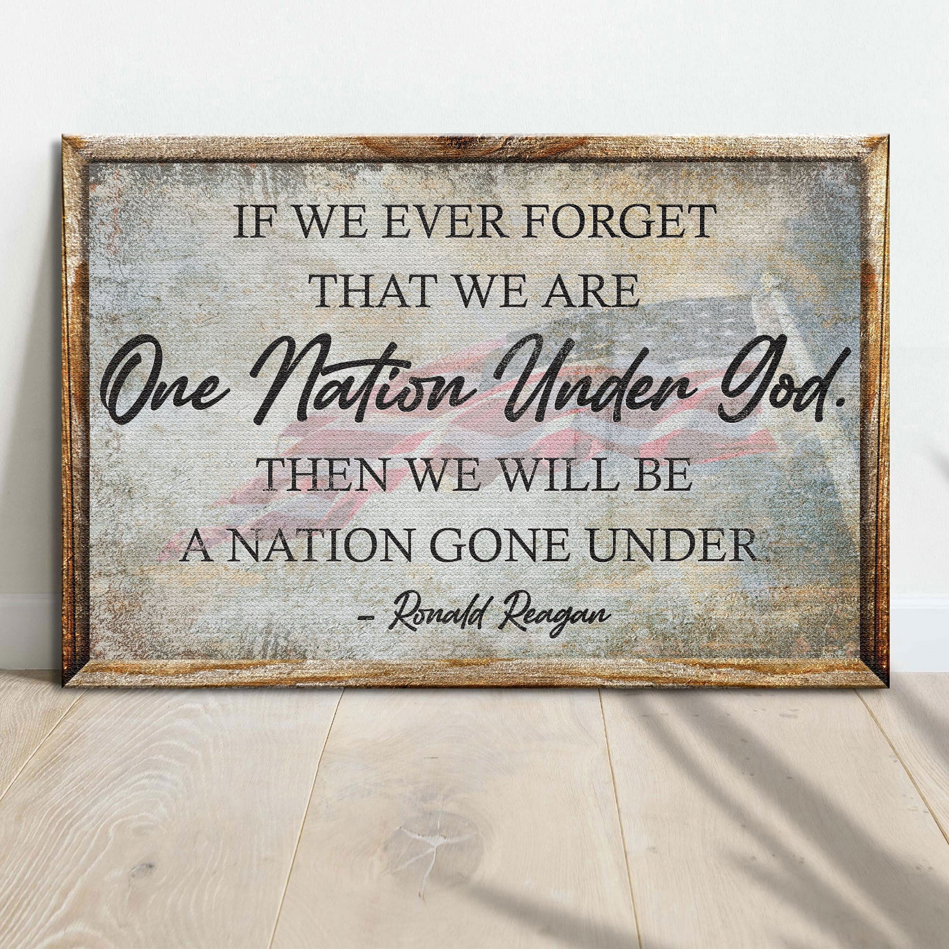 Wooden sign with engraved text and American flag on a light wooden floor.