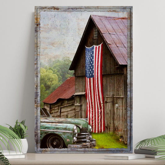 Framed artwork of a rustic scene with a barn and American flag, displayed on a wall.