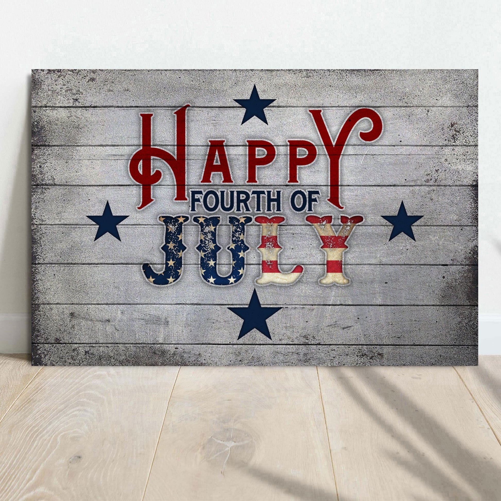 Wooden sign with 'Happy Fourth of July' text on a wooden floor.