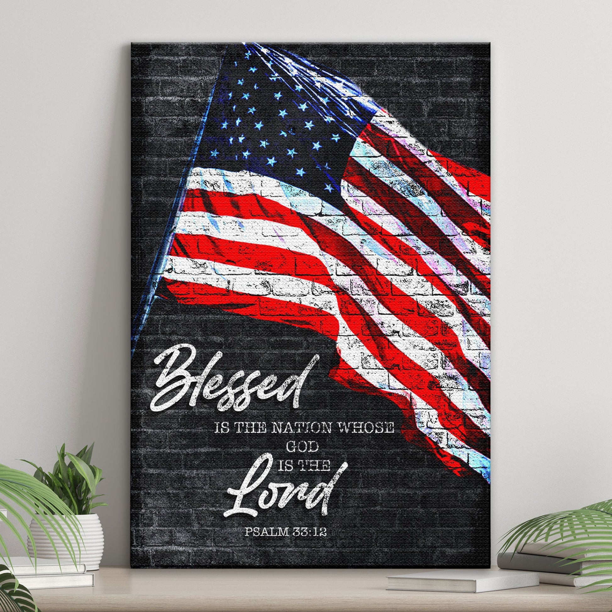 American flag on a brick wall with 'Blessed is the nation whose God is the Lord' text, placed on a shelf.