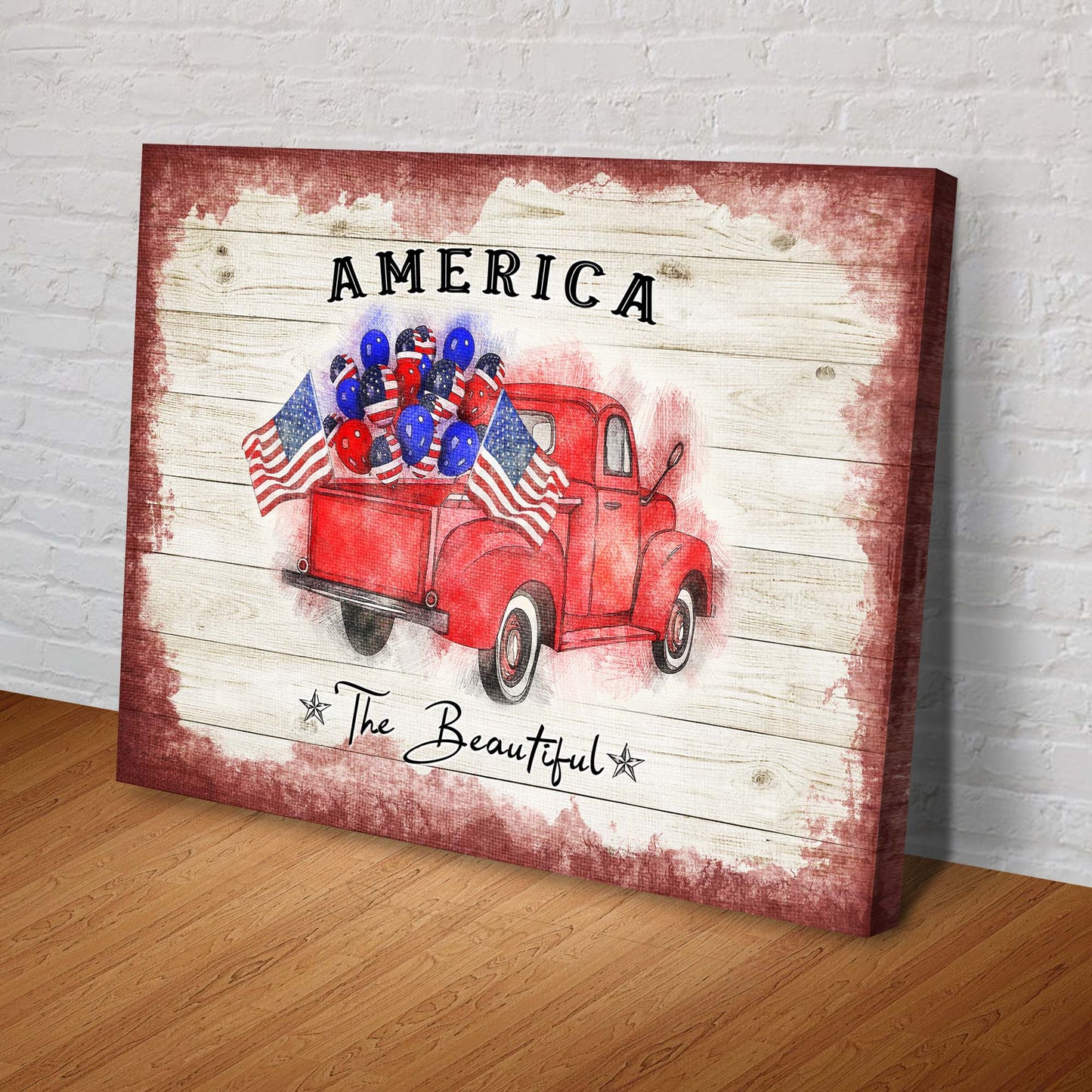 Canvas print with a red truck, American flags, and balloons on a wooden background.
