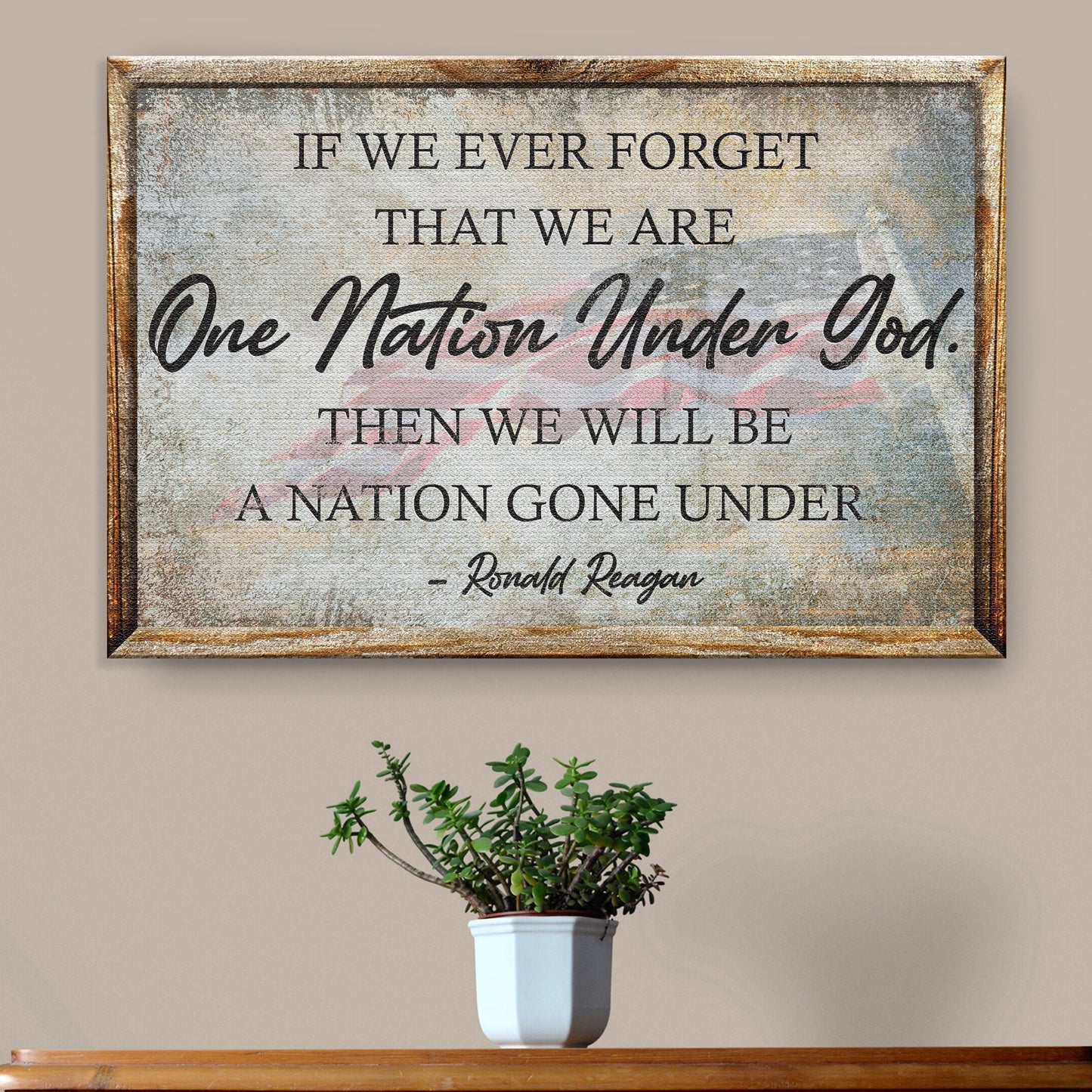 Framed sign with Ronald Reagan quote on a wall above a plant