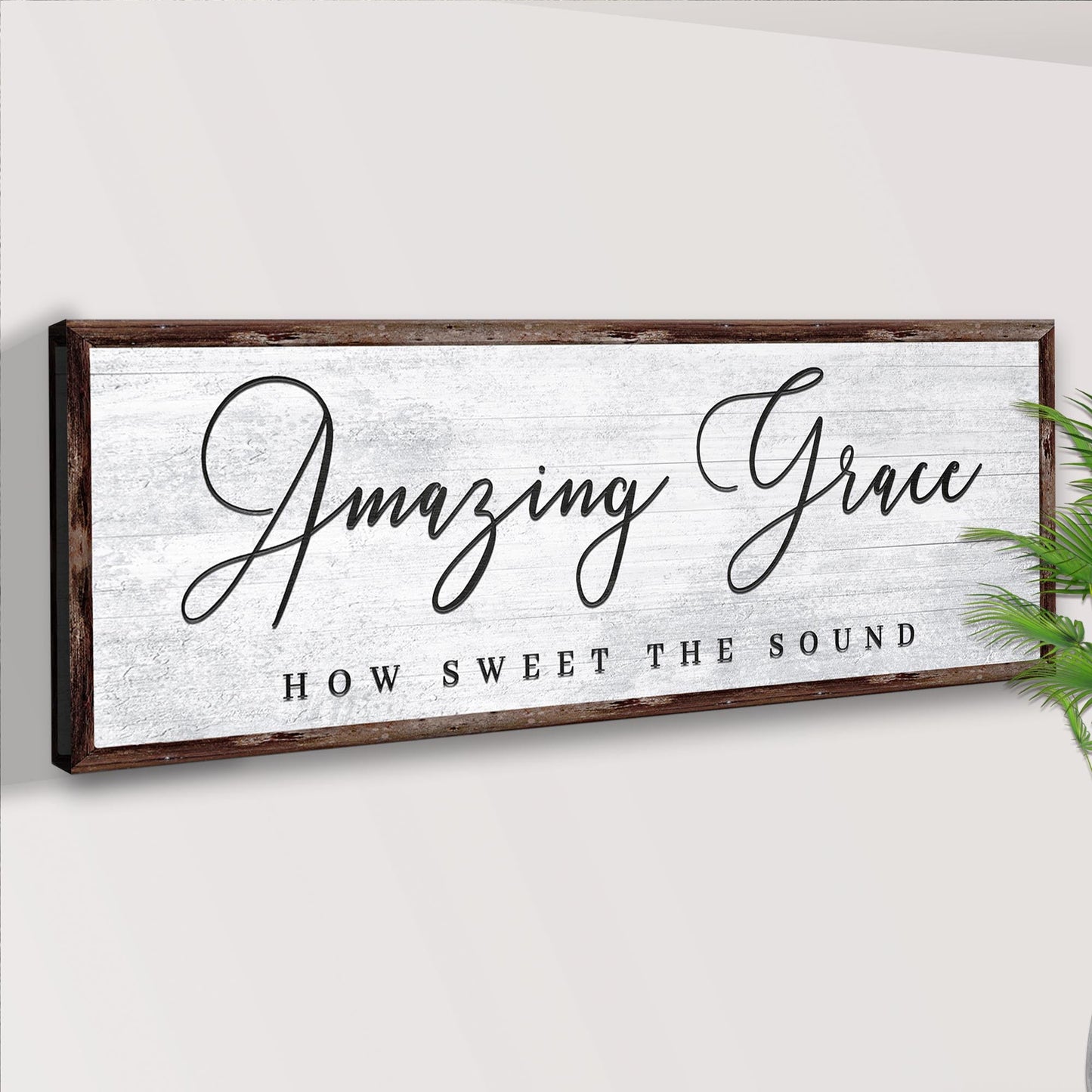 Decorative sign with 'Amazing Grace' text on a white wall.