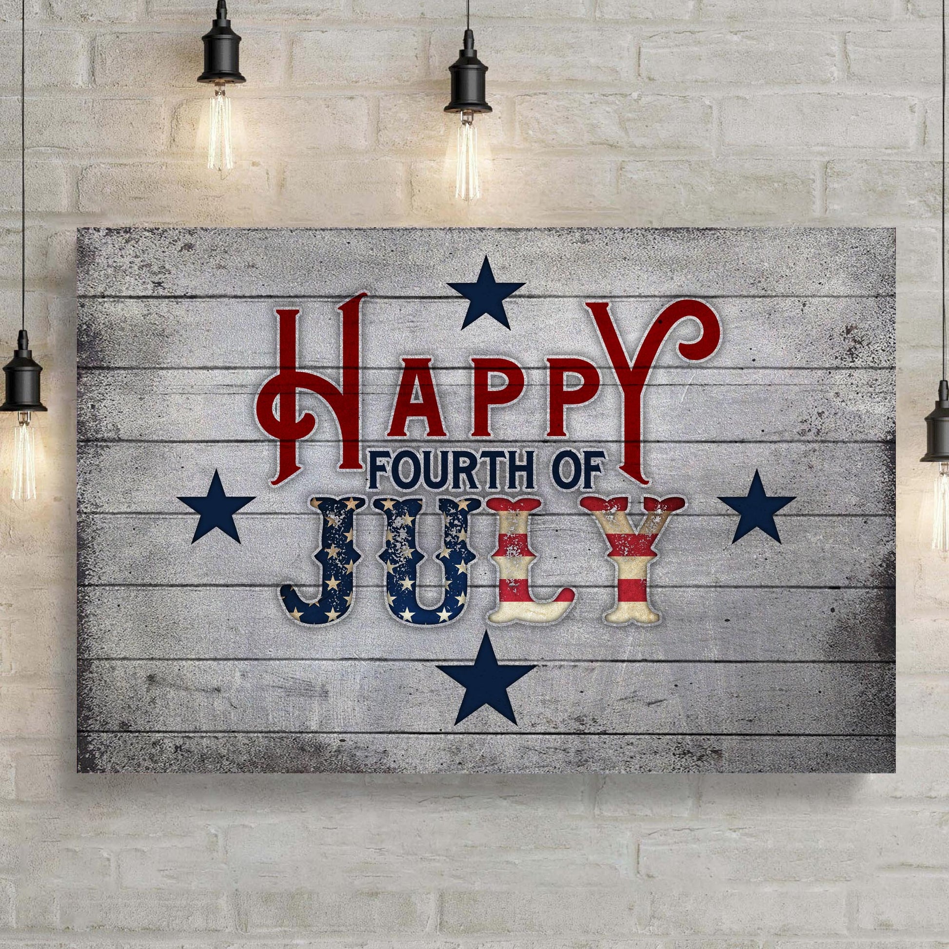 Decorative sign with 'Happy Fourth of July' text on a wooden background, hanging on a brick wall.