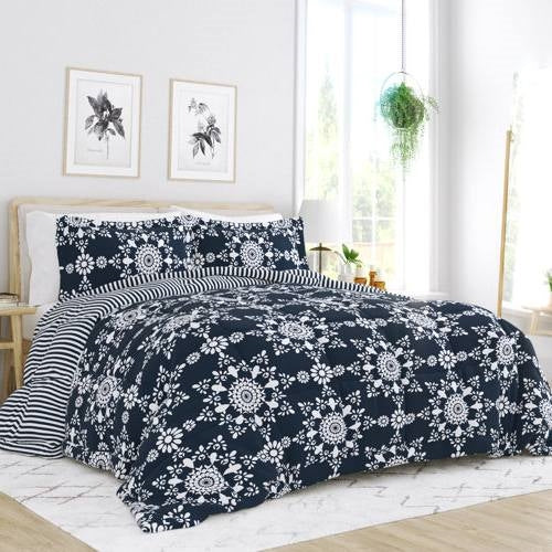 Twin 3-Piece Navy Blue White Reversible Floral Striped Comforter Set displayed in a bright, stylish bedroom setting.