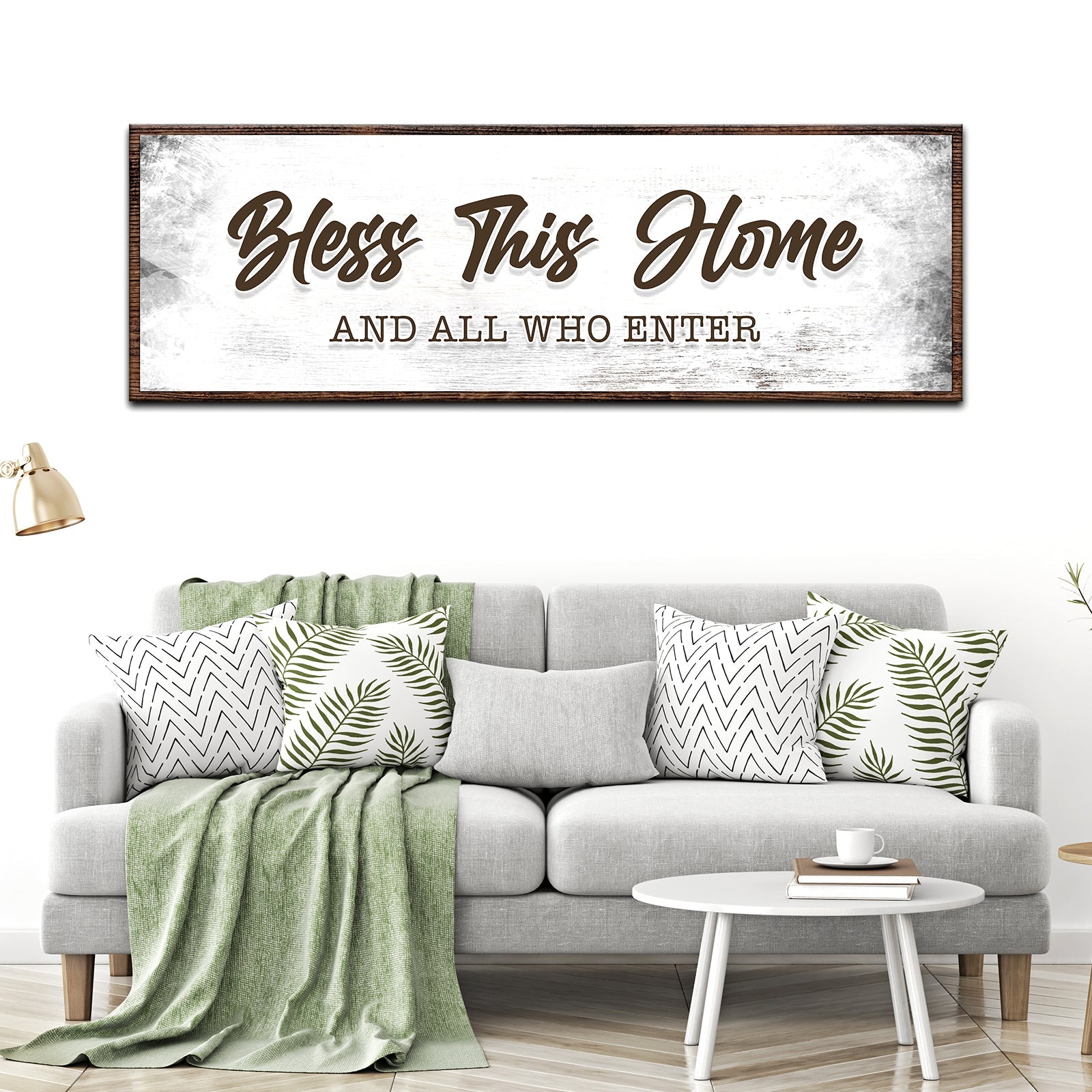 Living room with a gray sofa, decorative pillows, and a large framed sign above it.