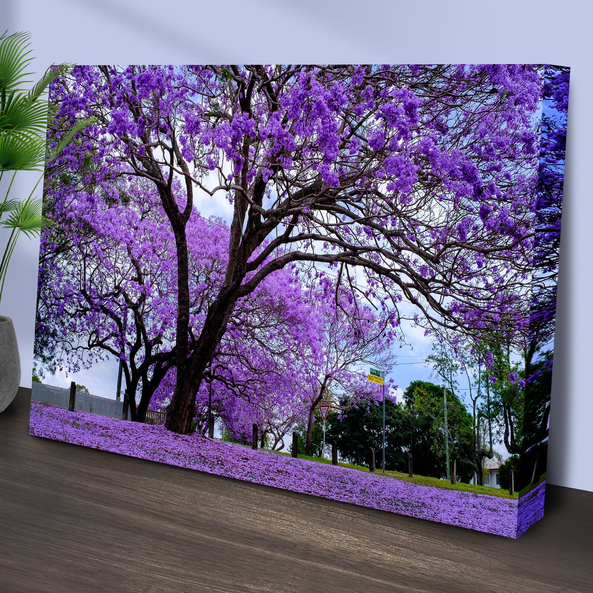Canvas print of a purple flowering tree on a wooden surface.