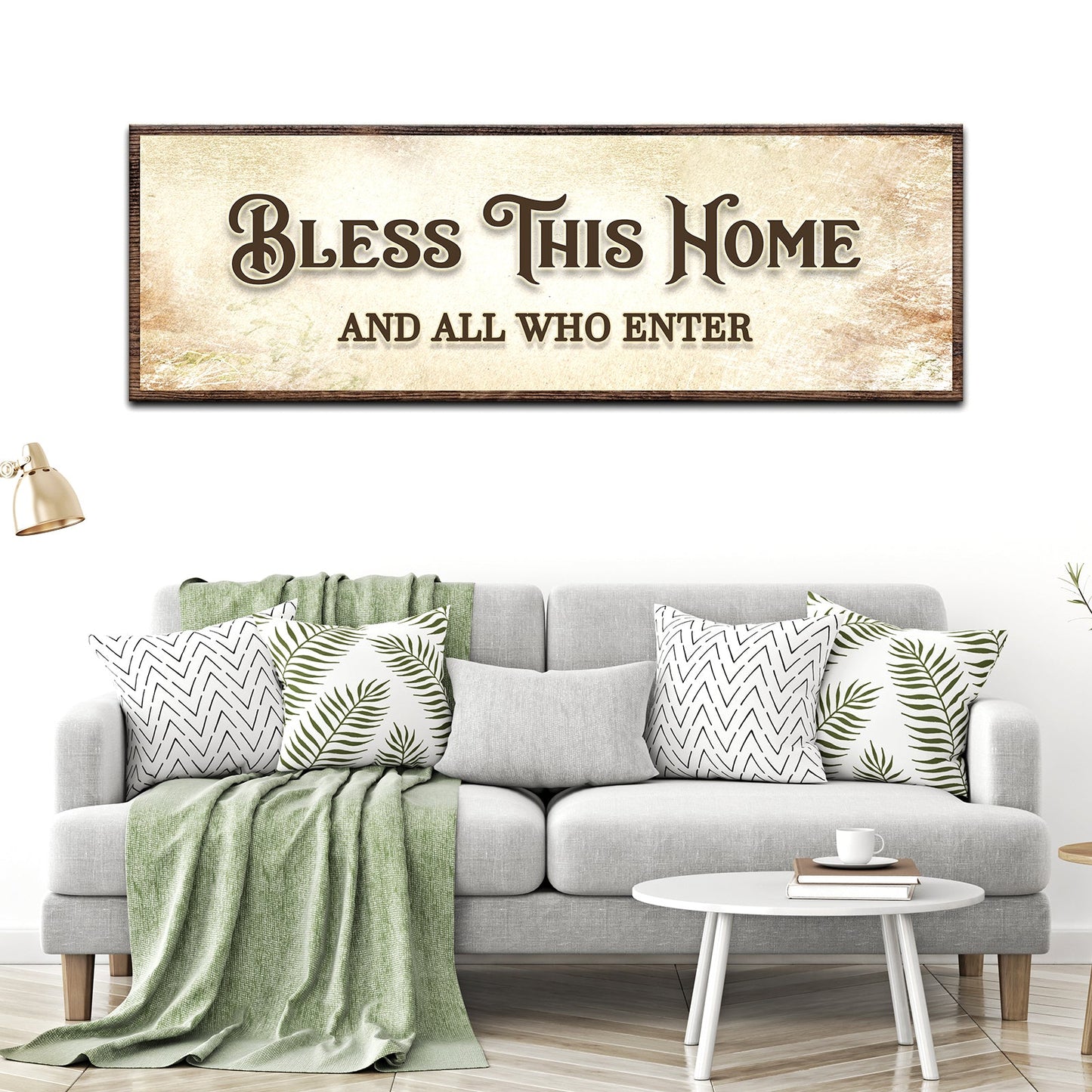 Living room with a gray sofa, decorative pillows, and a framed sign above it.