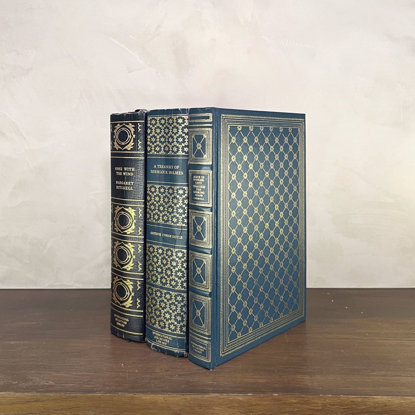 Vintage Blue Gilded Books displayed on a shelf with intricate gilded bindings and rich blue hues.