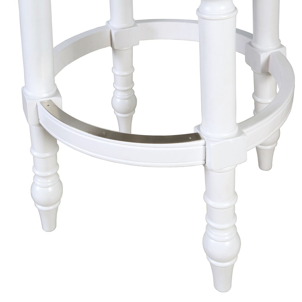 Detailed view of the Gastonia Swivel Stool In White, showcasing its elegant wooden legs and metal trimmed footrest.