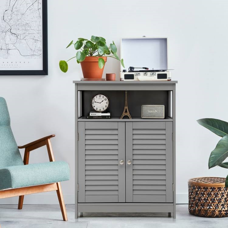 Gray cabinet with decorative items in a room with a chair and plants.