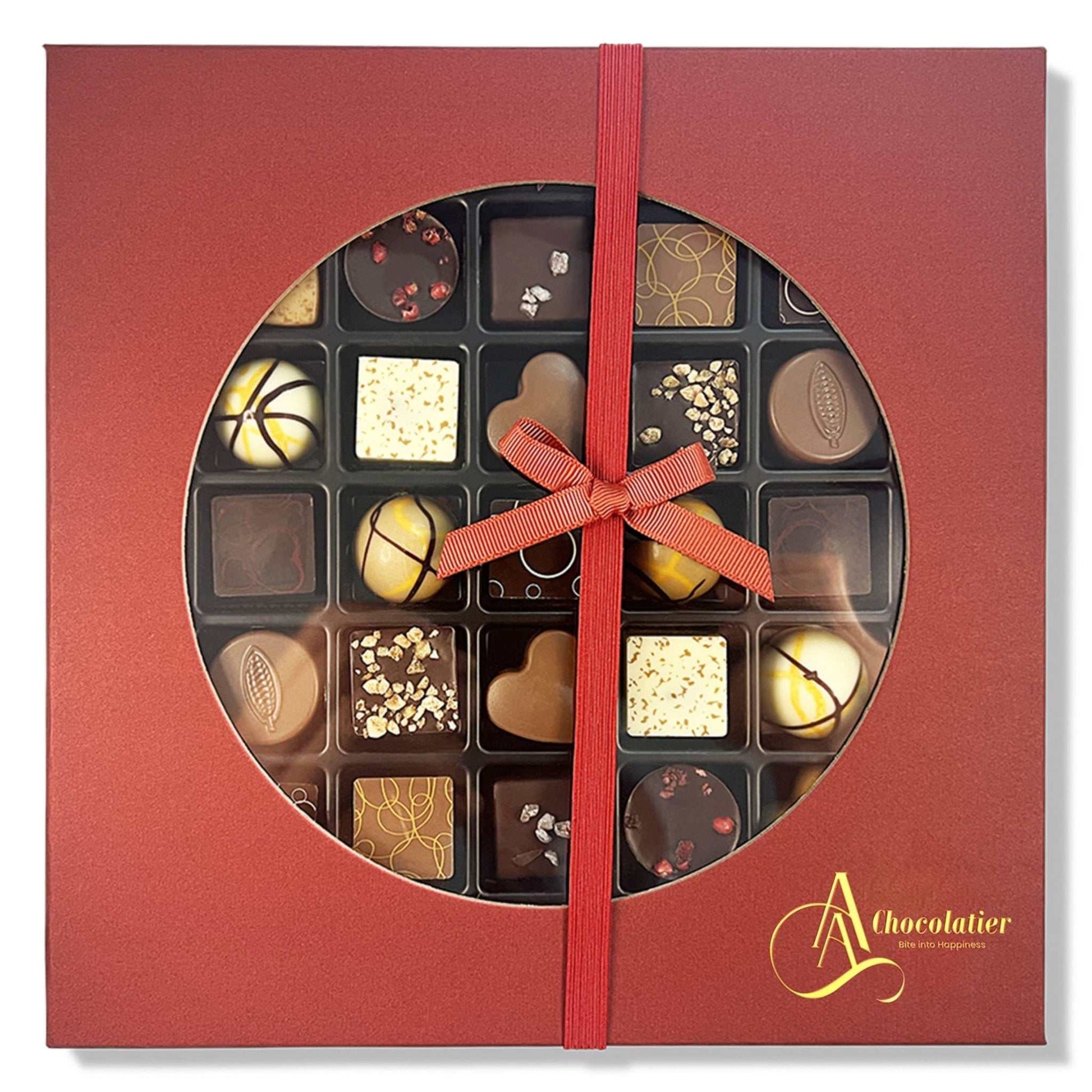 Red chocolate box with a ribbon and various chocolates inside, featuring the brand 'A Chocolatier'.