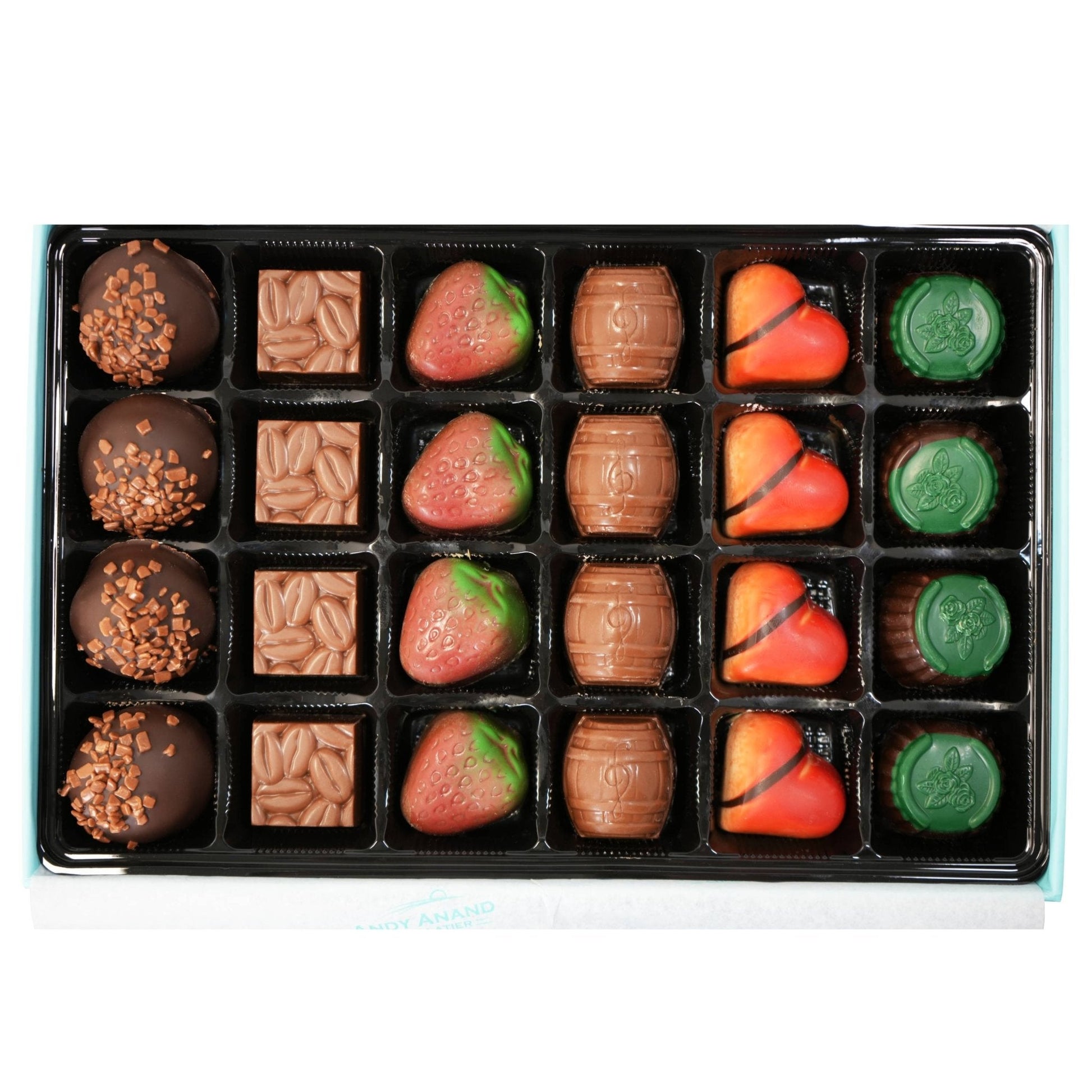 Assorted chocolates including strawberries and nuts in a box on a white background