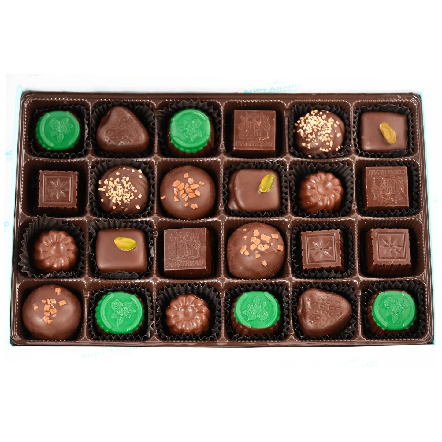 Assorted chocolates in a box with green and brown colors on a white background