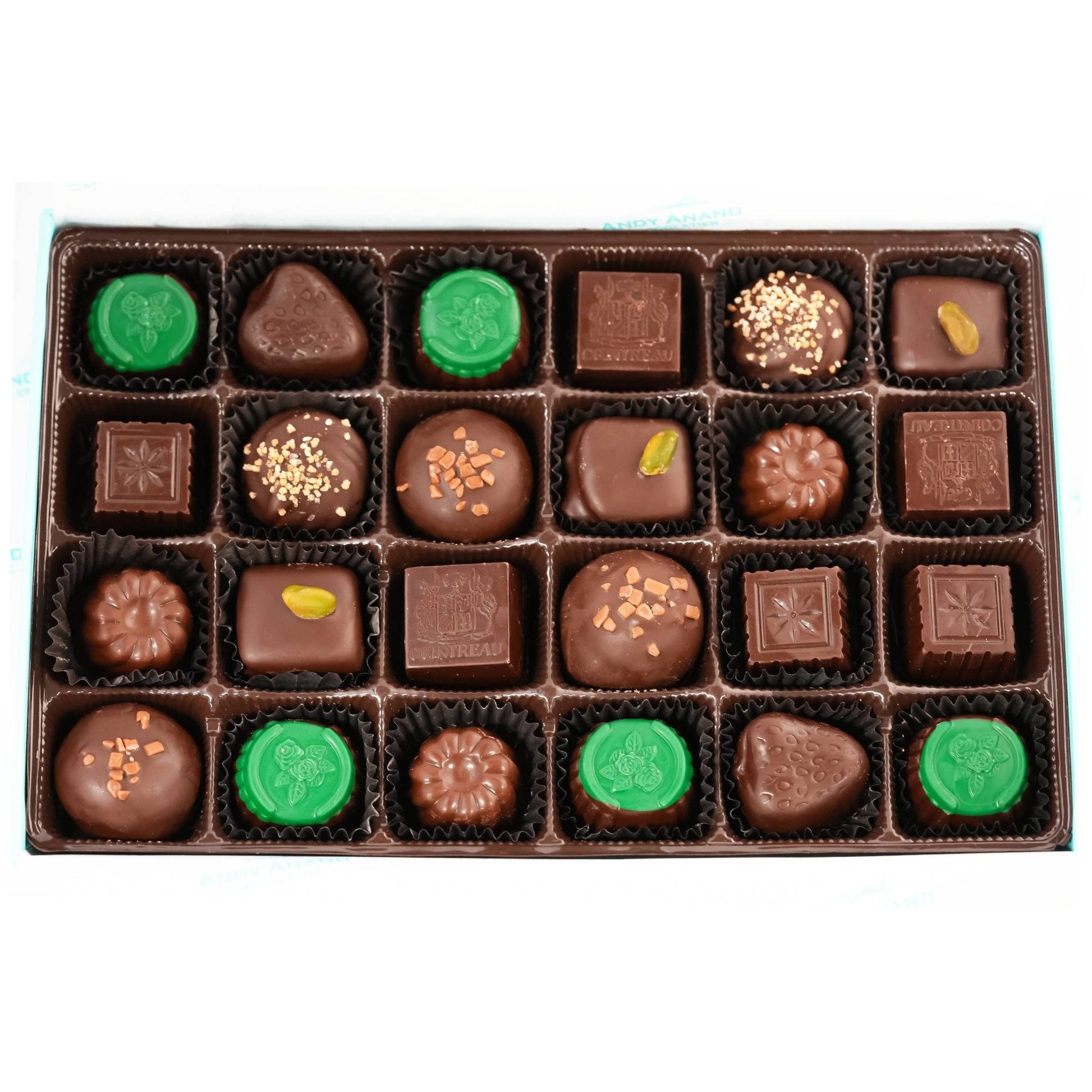 Assorted chocolates in a box with green and brown colors on a white background