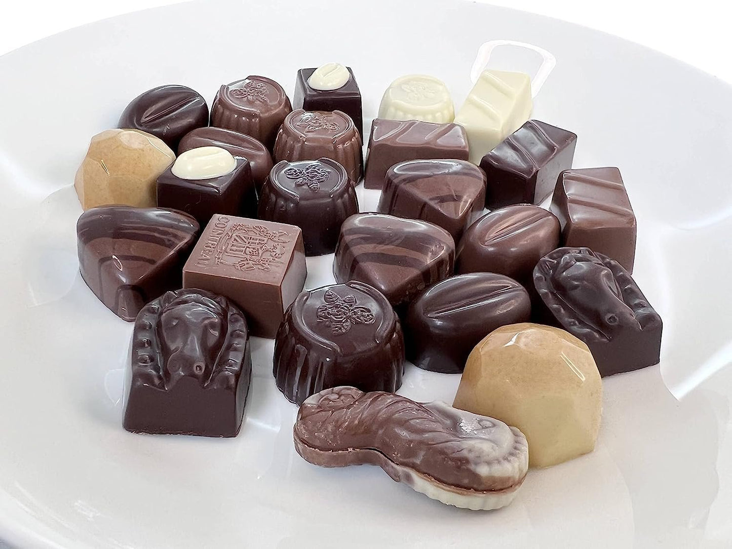 Assorted chocolate candies on a white plate