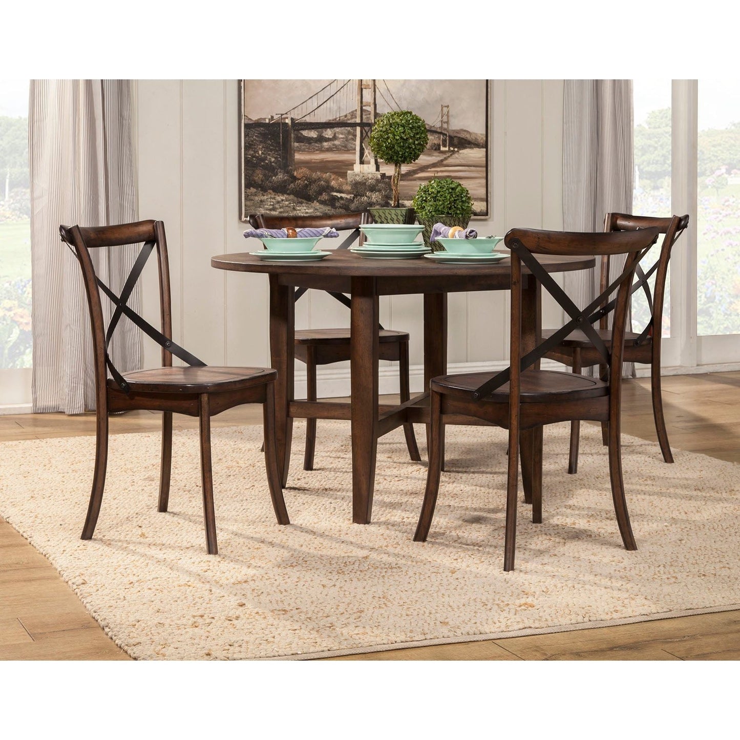 Arendal Round Table in Dark Burnished Oak with metal cross-back chairs, perfect for rustic and industrial dining.