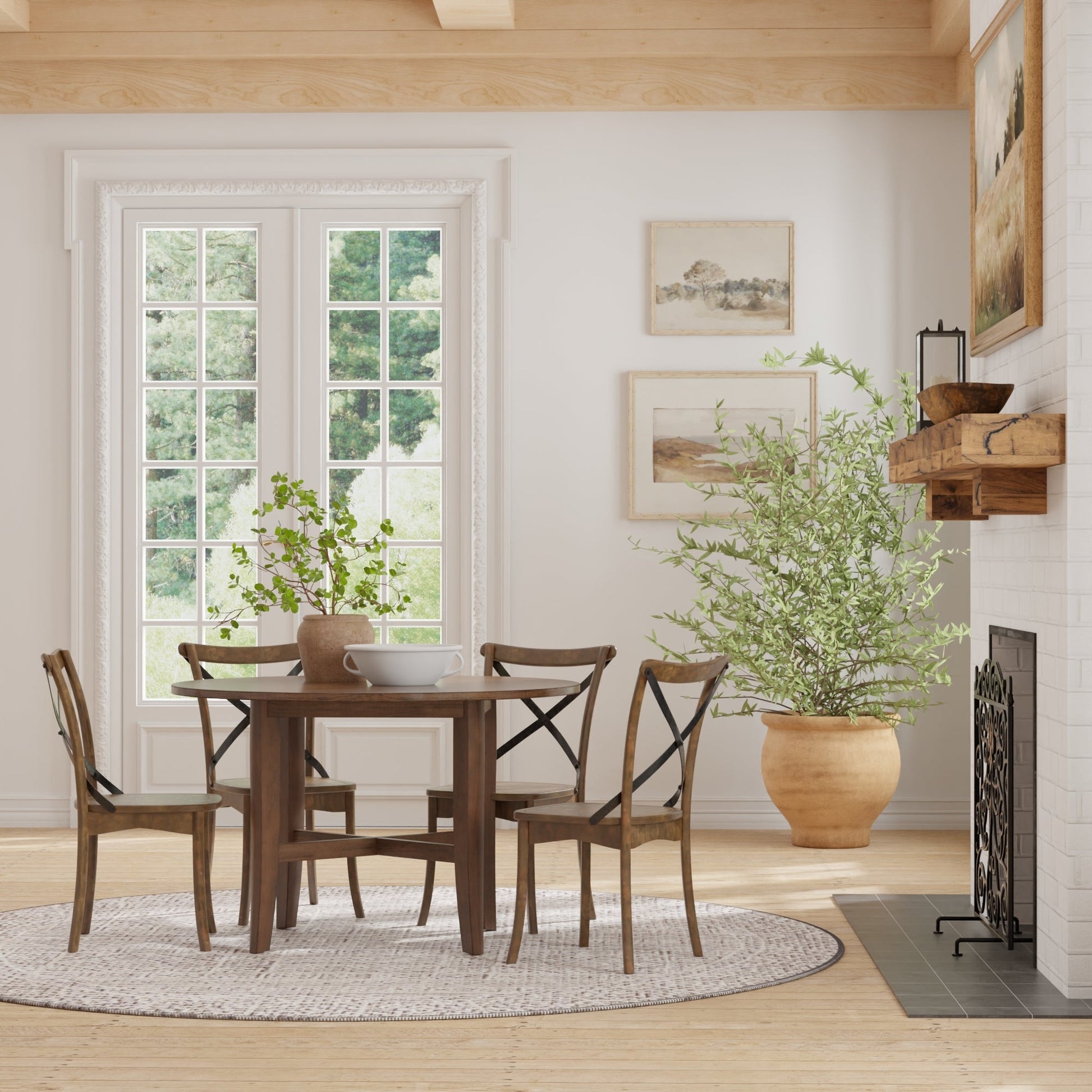 Arendal Round Table in a rustic dining room with cross-back chairs and natural light.