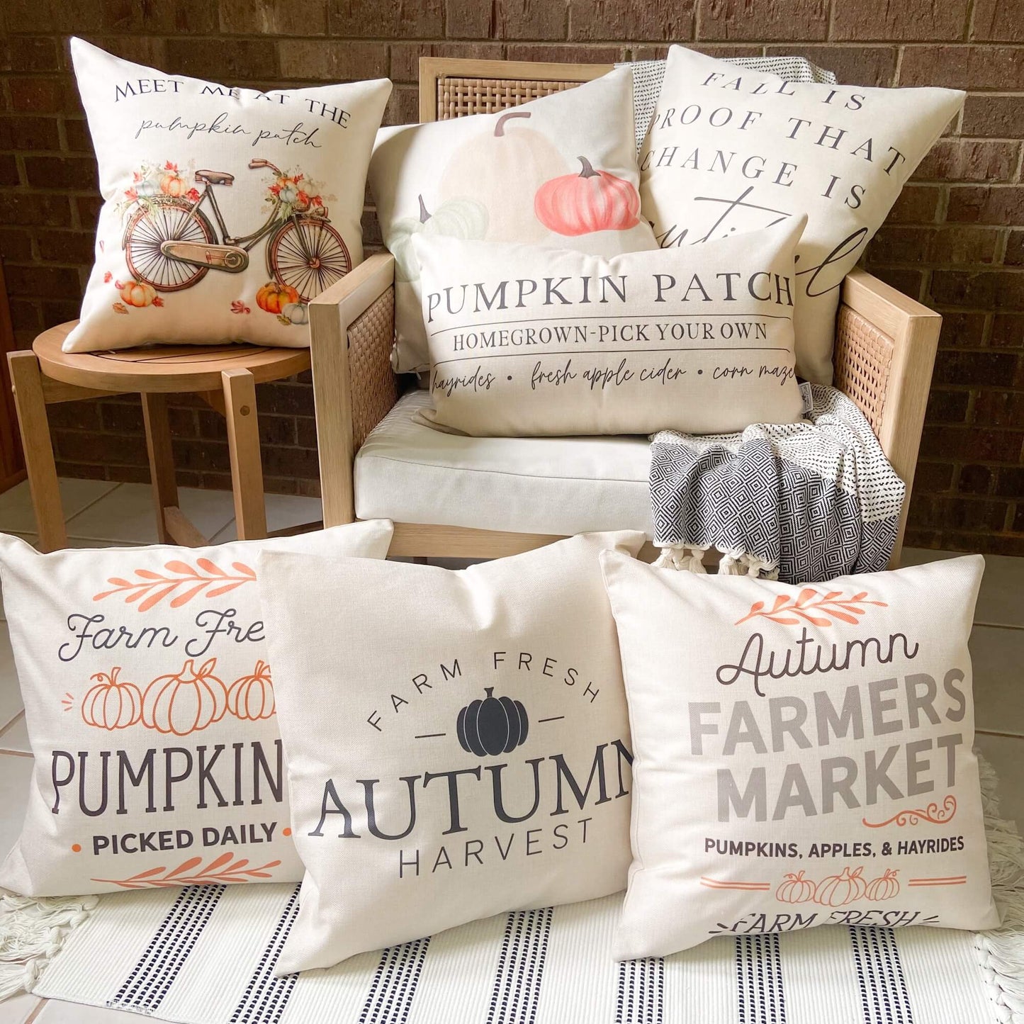 Pumpkins Apples Hayrides Pillow Cover 18x18 inch decorative pillows displayed on a cozy chair for autumn decor