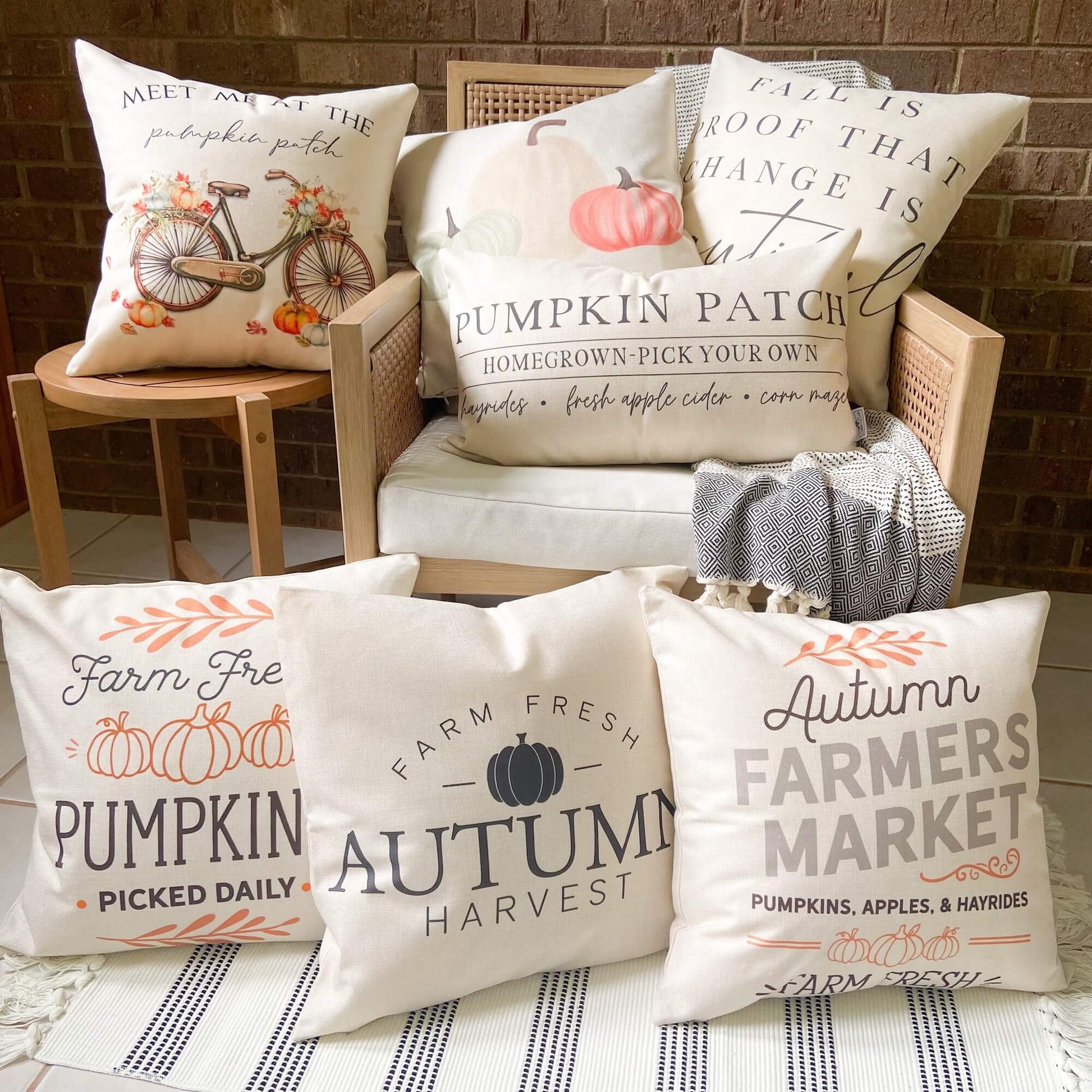 Pumpkins Apples Hayrides Pillow Cover 18x18 inch decorative pillows displayed on a cozy chair for autumn decor