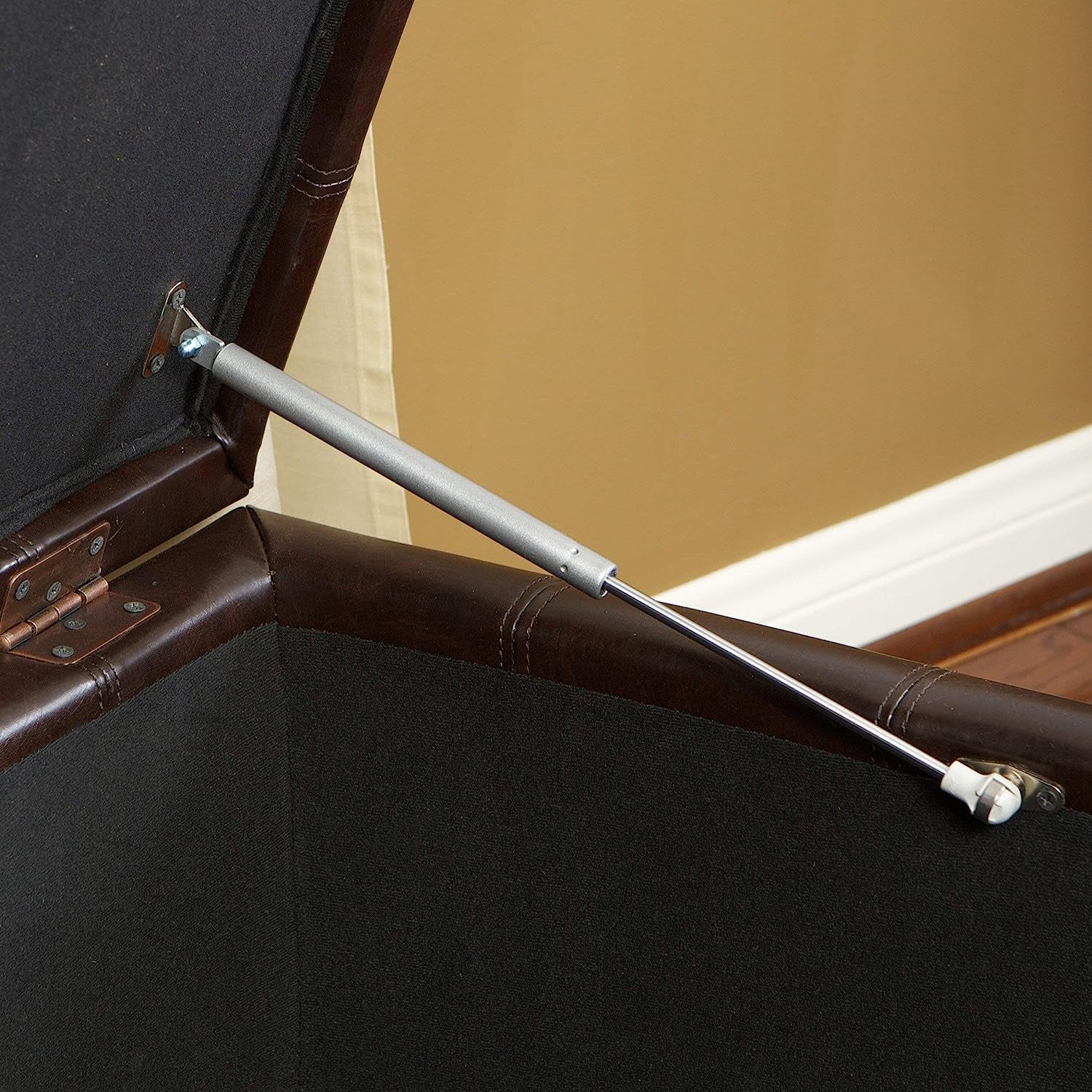 Close-up of the hinge mechanism inside a Marbled Brown Leather Storage Ottoman for Living Room, showcasing its sturdy design.