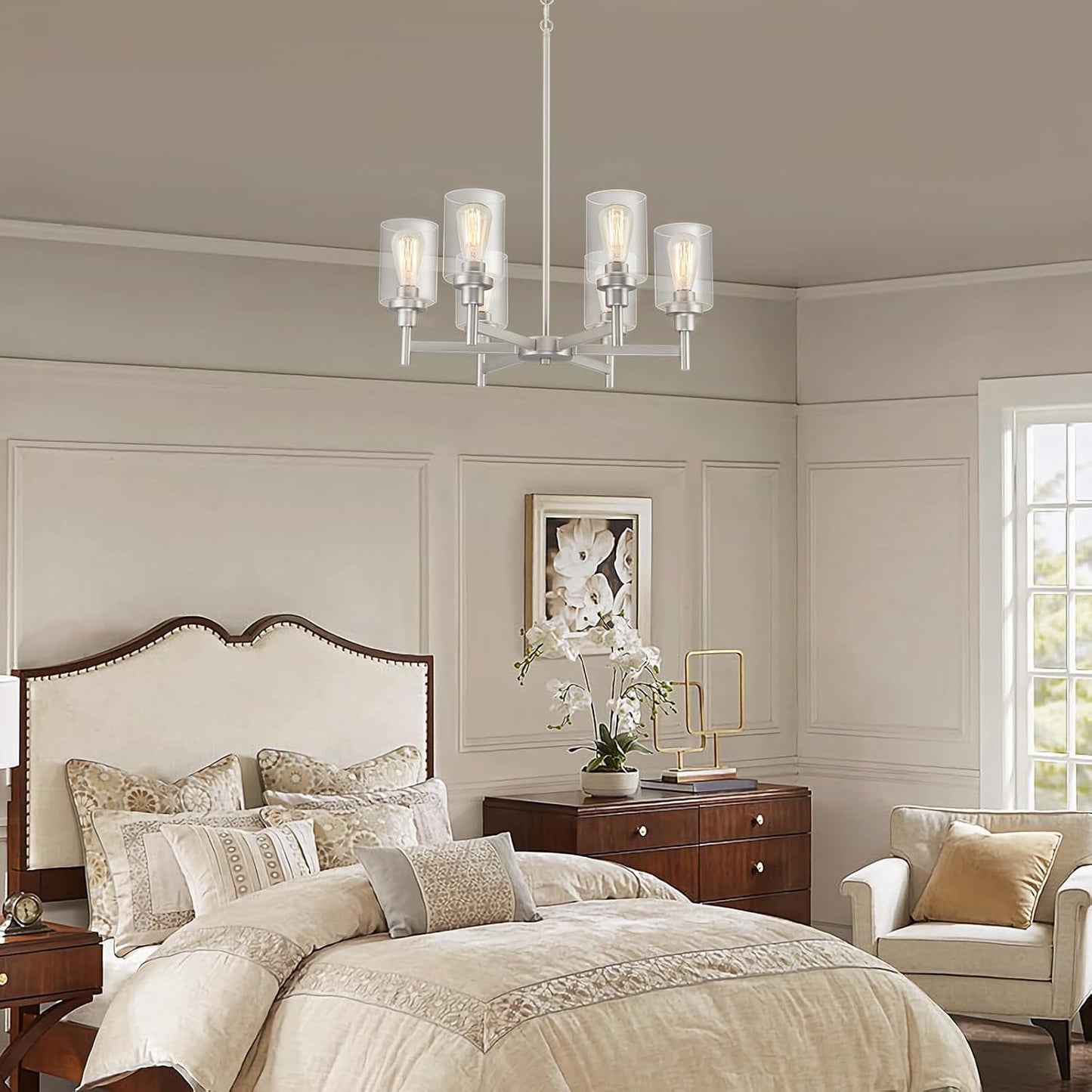 Brushed Nickel Six Light Chandelier With Clear Glass Shades illuminating a stylish bedroom setting.