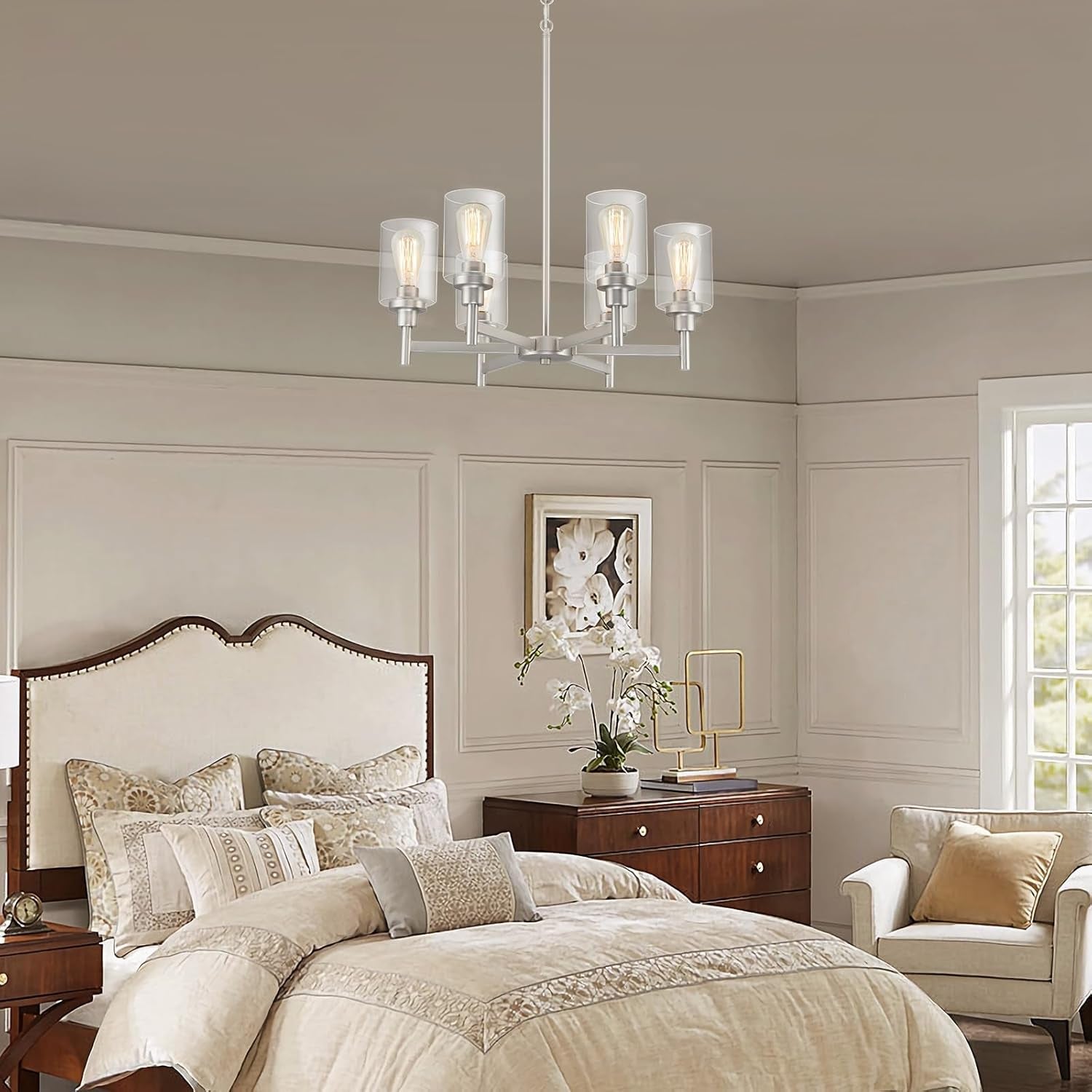 Brushed Nickel Six Light Chandelier With Clear Glass Shades illuminating a stylish bedroom setting.
