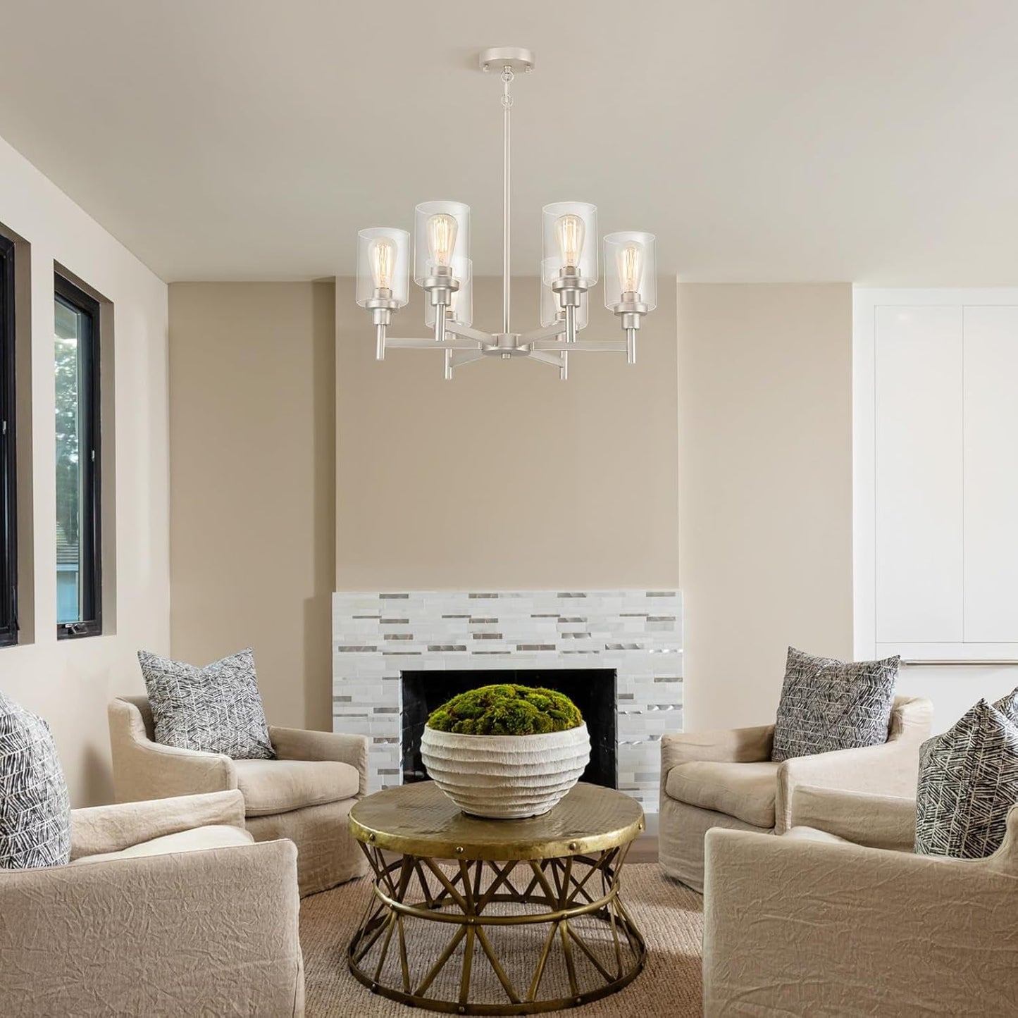 Brushed Nickel Six Light Chandelier With Clear Glass Shades above a cozy living room seating area.