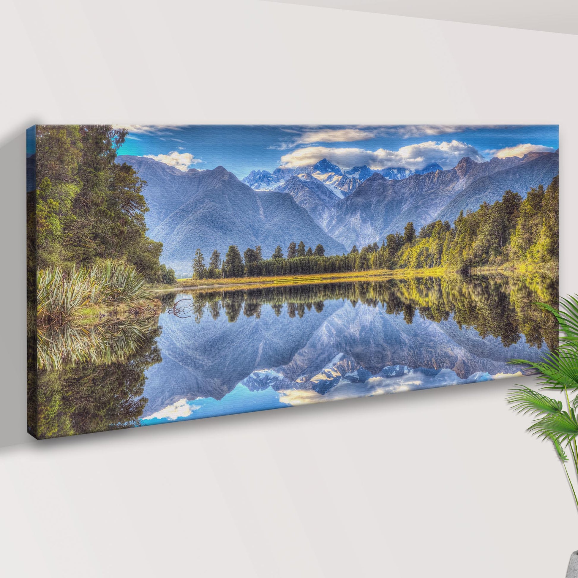 Canvas print of a mountain landscape with a lake on a white wall.