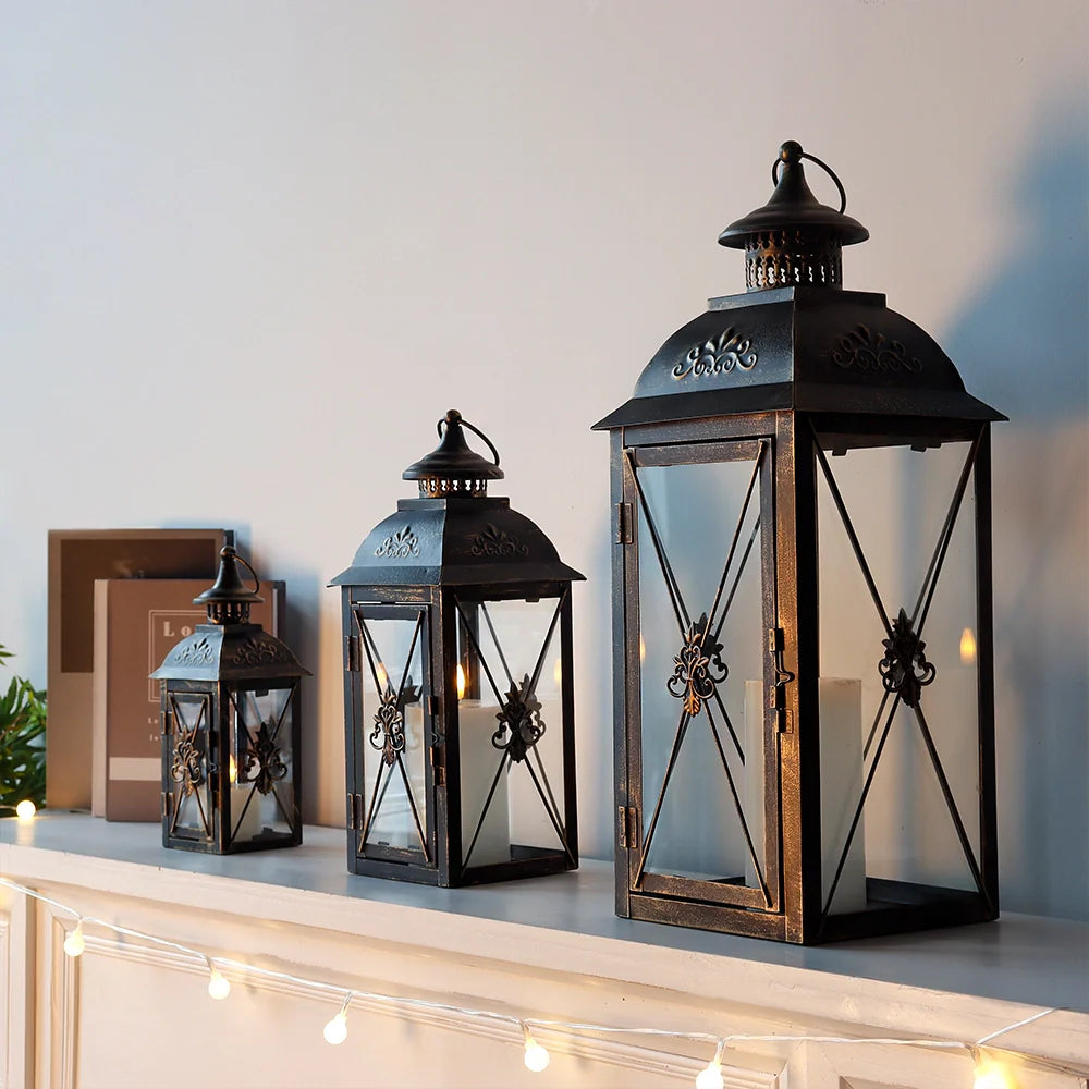Set of 3- 19'' High Decorative Hanging Lantern Black 13.5'' & 9.5'' displayed on a shelf with warm lighting.