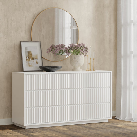 Blanca Dresser in white finish with scalloped design, styled with mirror and decorative elements in a modern bedroom setting.