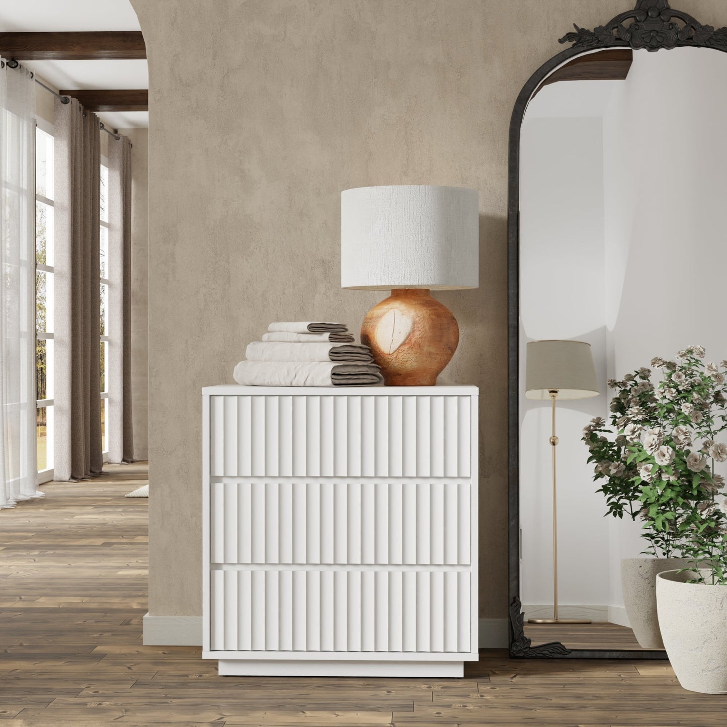 Elegant Blanca Small Chest in white finish with decorative lamp and towels, enhancing a stylish living space.
