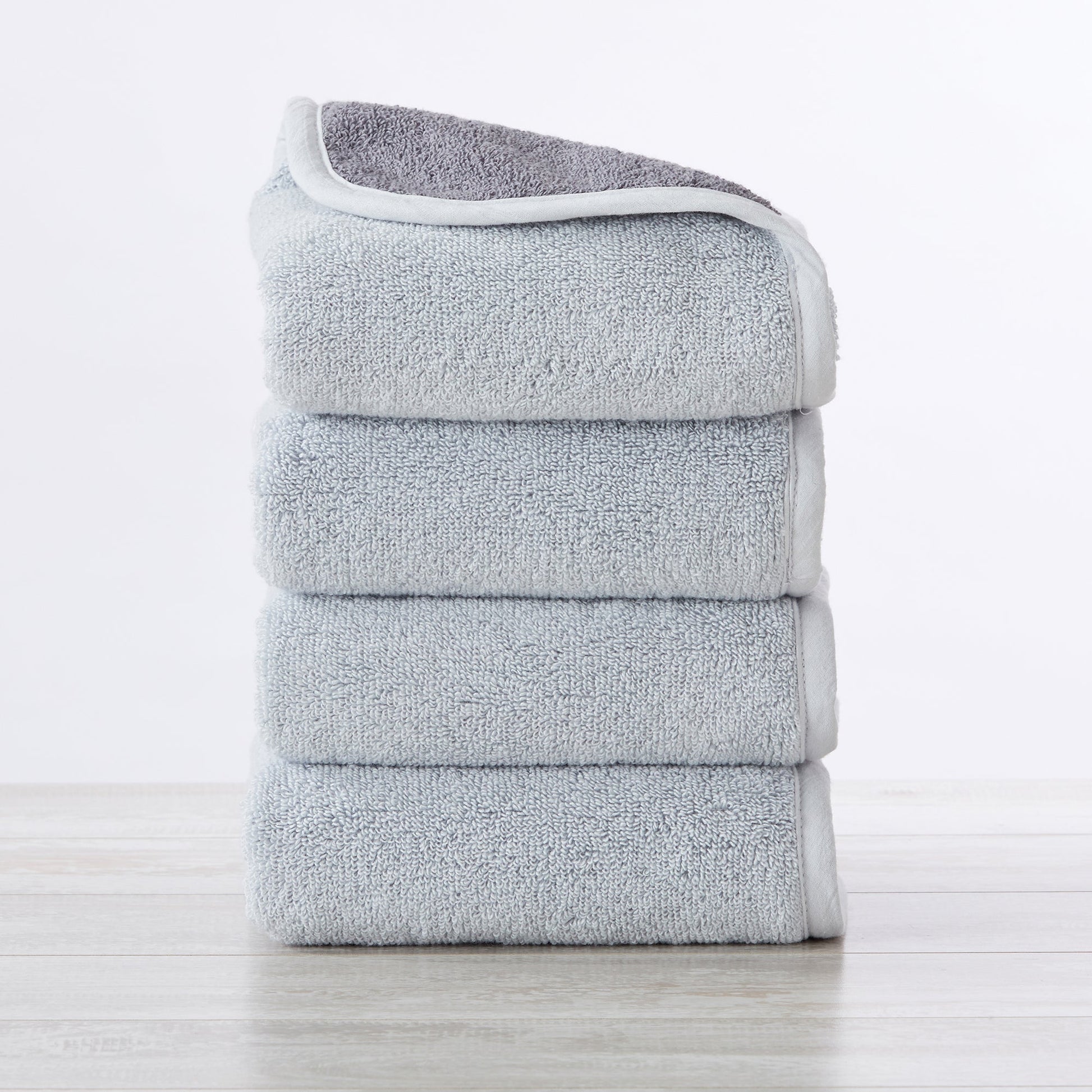 Stack of gray towels on a white background