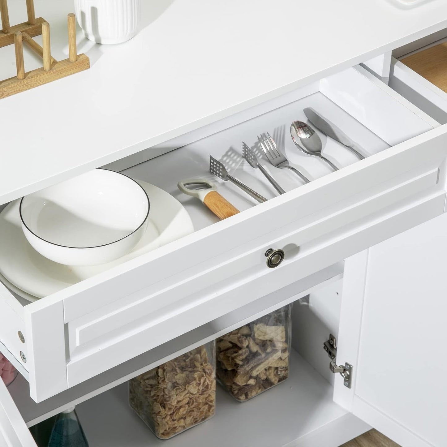 White Sideboard Buffet Cabinet drawer displaying utensils and plates, showcasing stylish and organized storage.