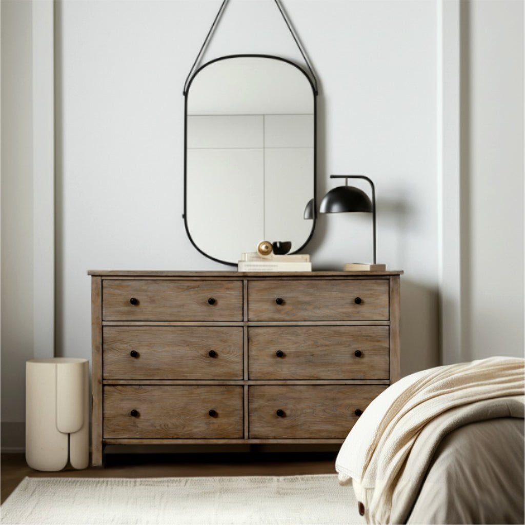 Classic Dresser featuring six drawers with brass knobs in Natural Gray finish, styled with a mirror and lamp.