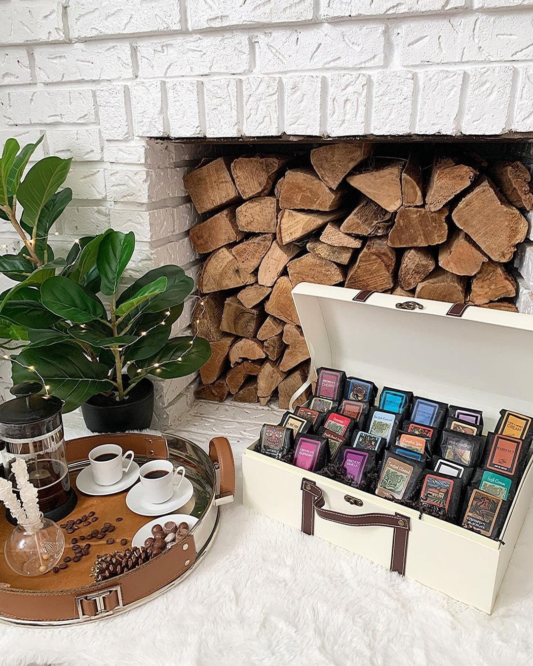 The Grand Sampler Coffee Gift Basket displayed near a cozy fireplace with decorative items.