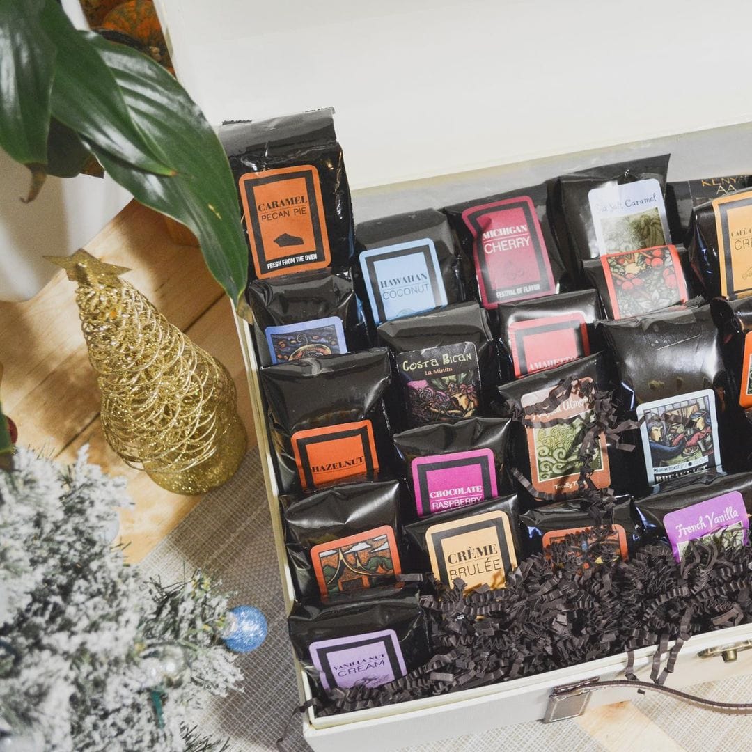 The Grand Sampler Coffee Gift Basket filled with a variety of gourmet coffee bags in an elegant gift box.