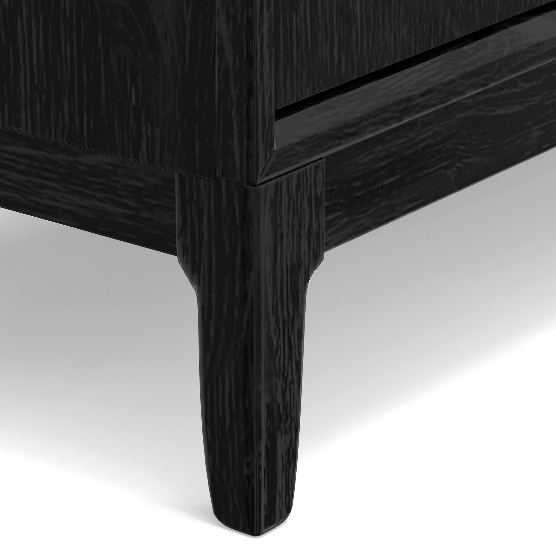 Close-up of the Cove Sideboard's vintage black finish and elegantly designed legs.
