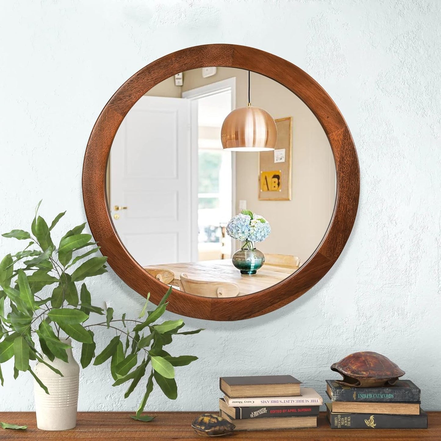 30 Inch Walnut Round Wall Mirror Rustic Style reflecting a stylish room with plants and decor.