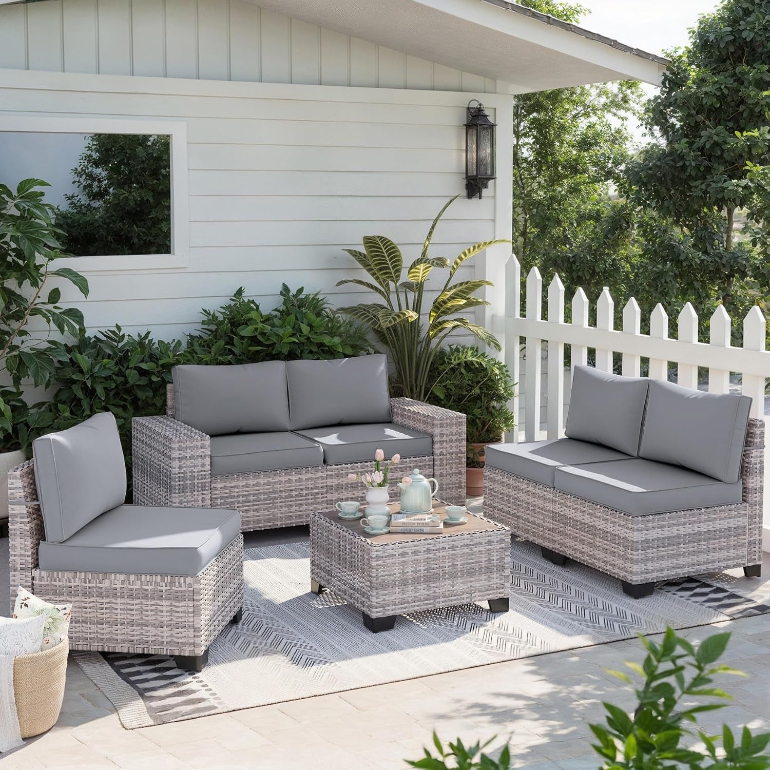 6-Piece Outdoor Wicker Patio Set With Grey Cushions arranged in a cozy outdoor living space.