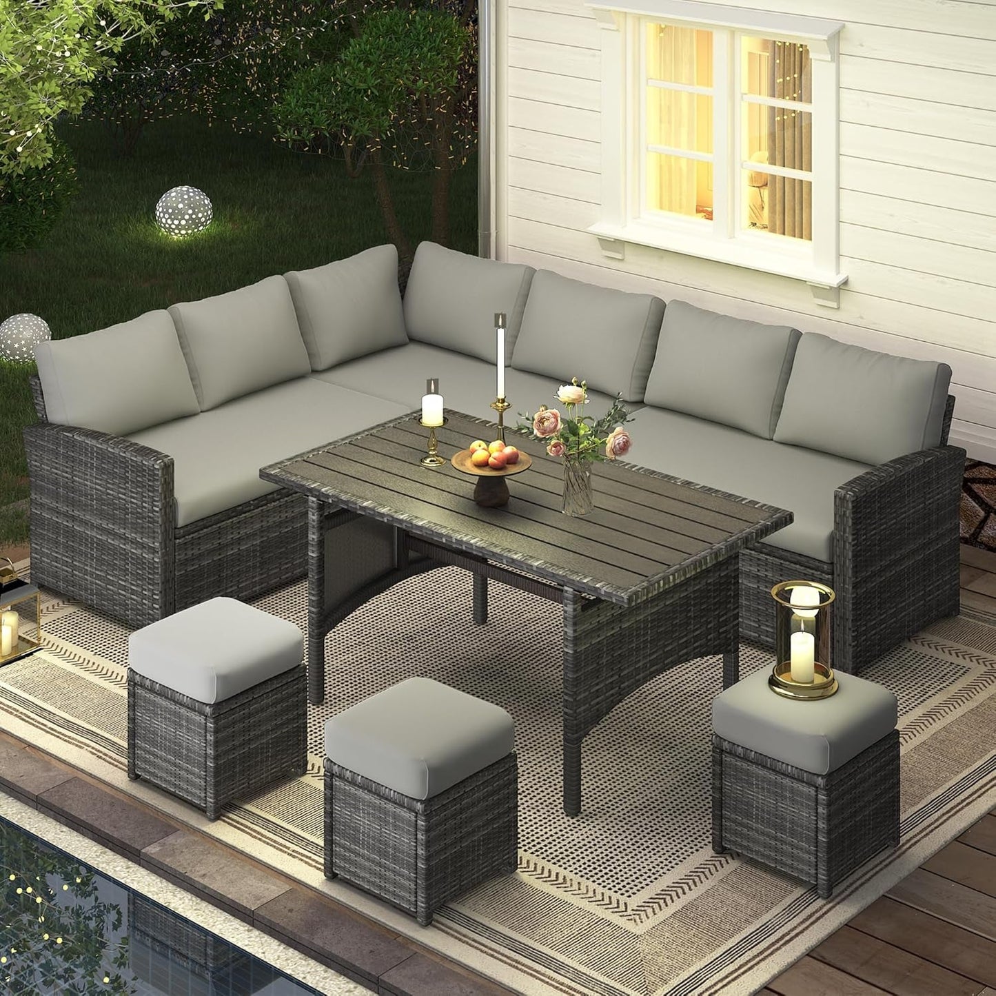 7 Piece Outdoor Patio Sectional Set All Weather Wicker Grey Cushions arranged on a patio with grey cushions and table.