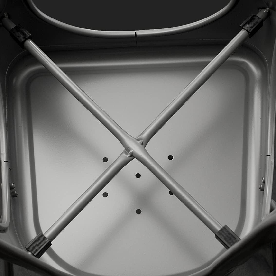 Close-up of a metal frame structure with X-shaped bars on a gray background