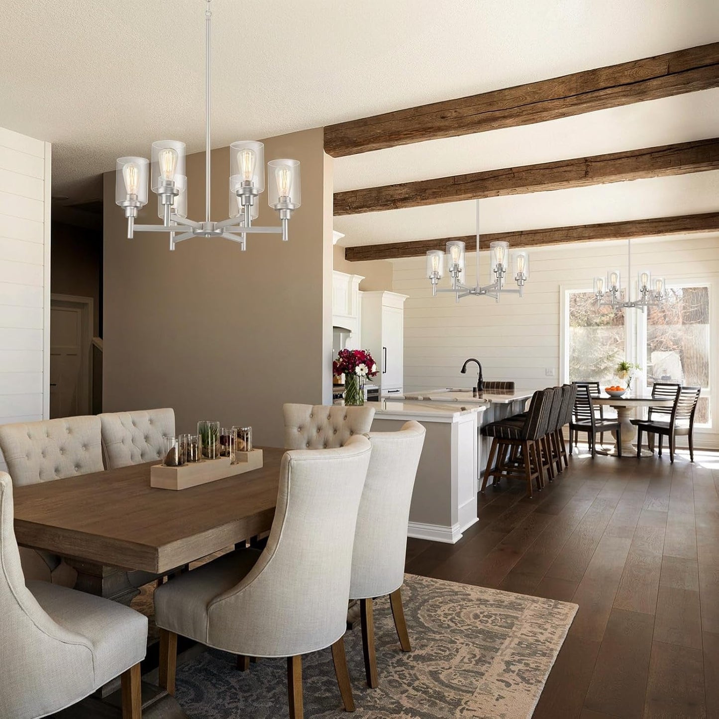 Brushed Nickel Six Light Chandelier With Clear Glass Shades illuminating a dining area with rustic decor.