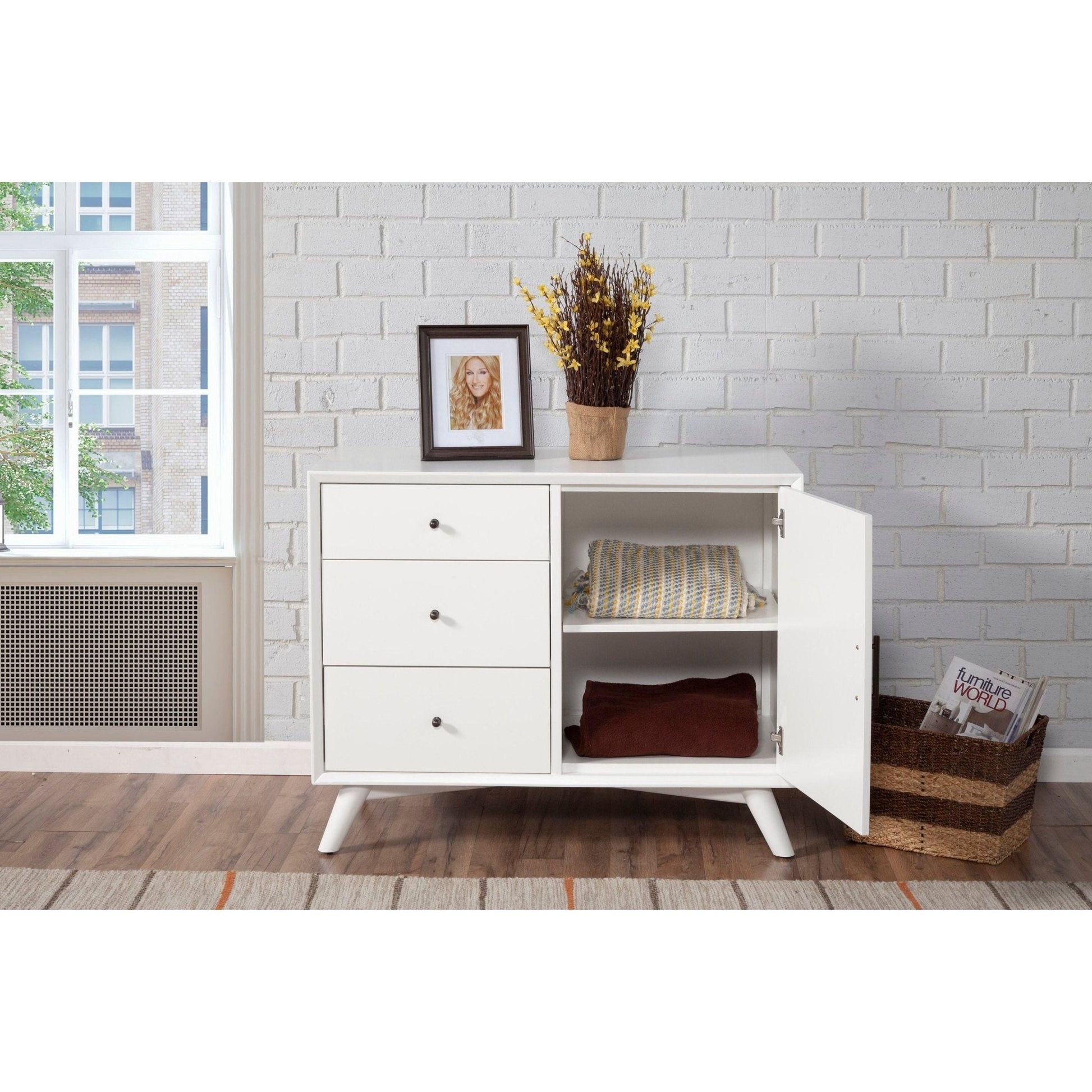 Flynn Accent Cabinet in white with three drawers and open shelving, styled in a modern living space.