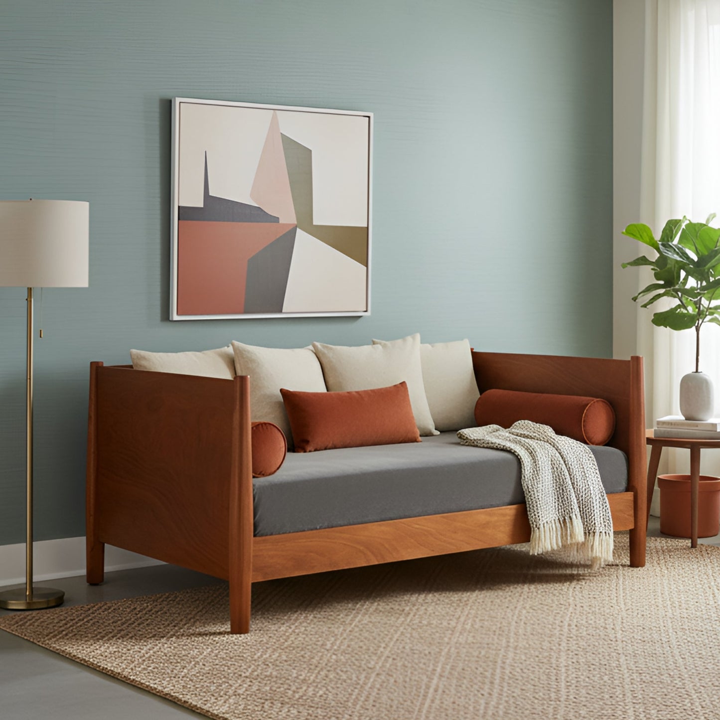 Flynn Day Bed in chestnut finish, styled with decorative pillows in a modern living room setting.